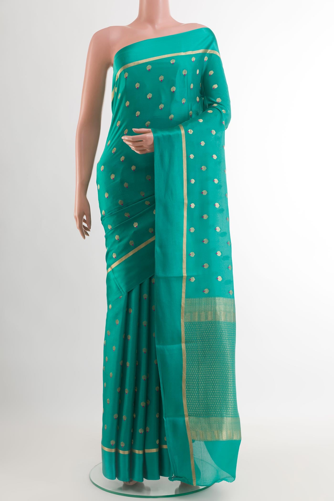 Sea Green Mysore Crepe Saree with Zari Butta on the body and Zari Border.  displayed on a mannequin