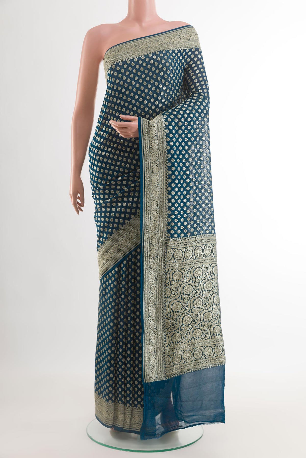 Dark Blue Banarasi Georgette Saree with Zari Butta on the body and Zari Border.  displayed on a mannequin