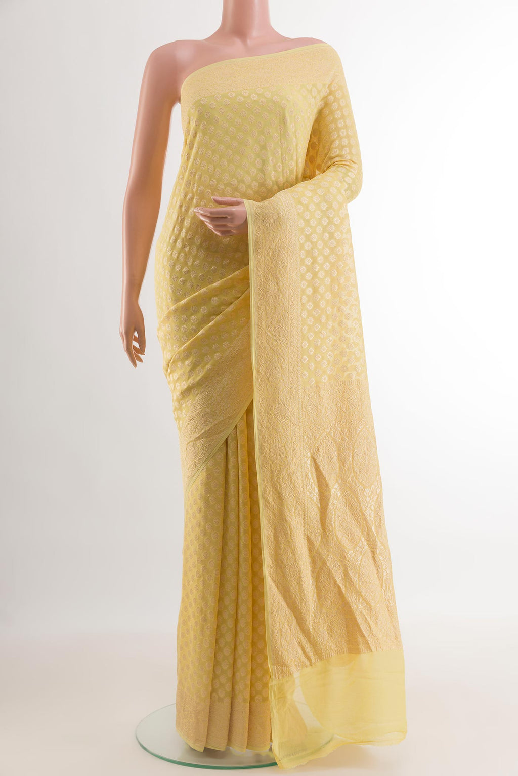 Yellow Banarasi Georgette Saree with Zari Butta on the body and Zari Border.  displayed on a mannequin
