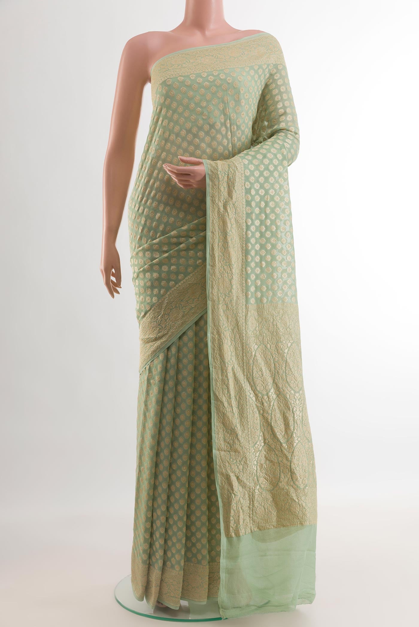 Mint Green Banarasi Georgette Saree with Zari Brocade on the body and Zari Border.  displayed on a mannequin