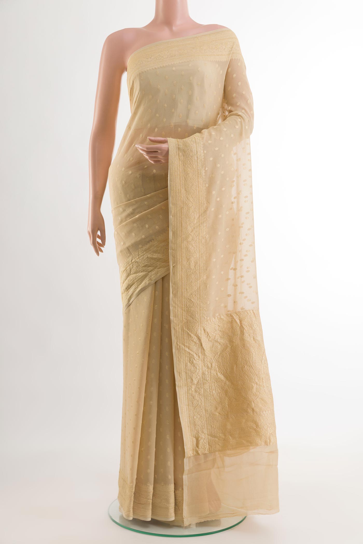 Beige Banarasi Georgette Saree with Zari Butta on the body and Zari Border.  displayed on a mannequin