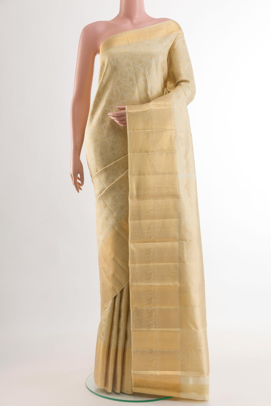 Beige Kanchipuram Silk Saree with Zari Brocade on the body and Zari Border.  displayed on a mannequin