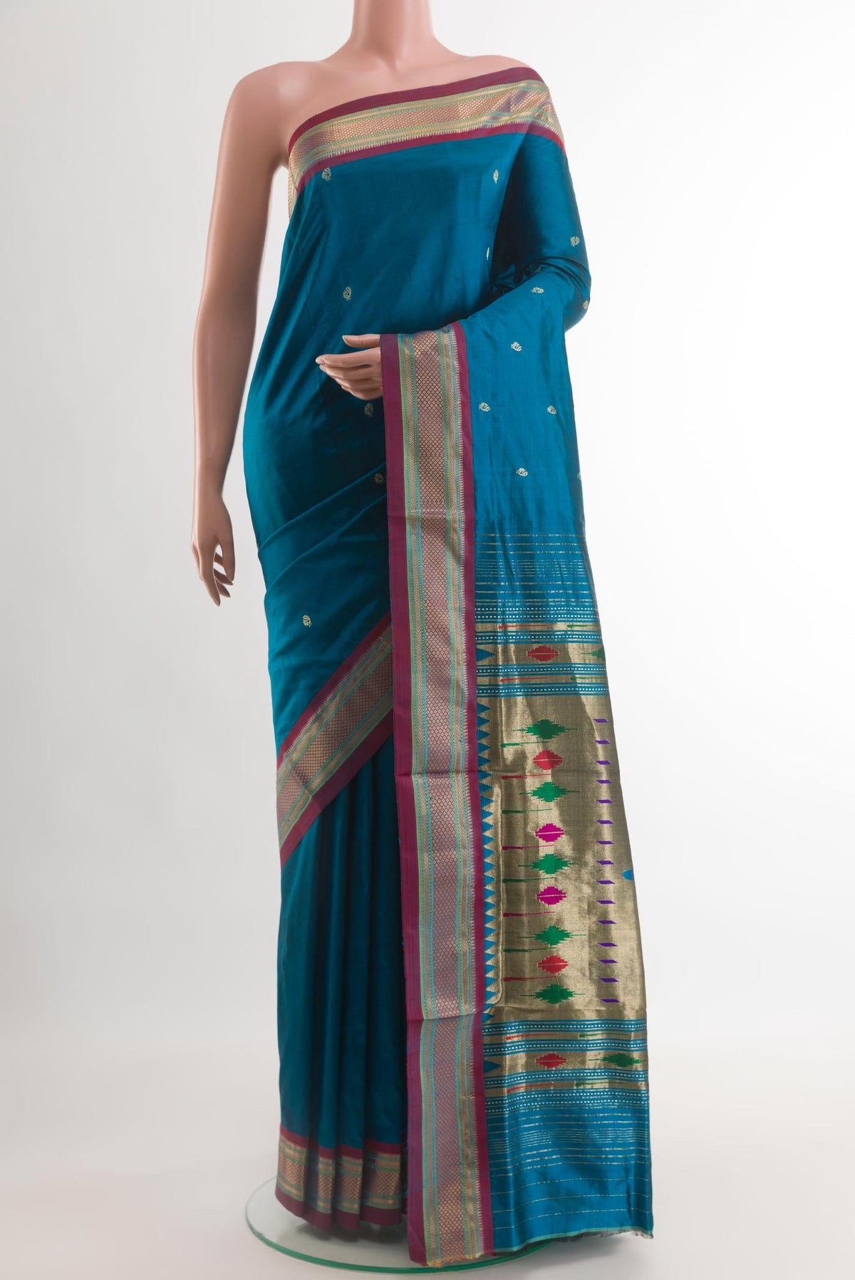 Blue Paithani Silk Saree with Zari Butta on the body and Zari Border.  displayed on a mannequin