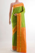 Parrot Green Kanchipuram Silk Saree with Zari Butta on the body and Zari Border.  displayed on a mannequin