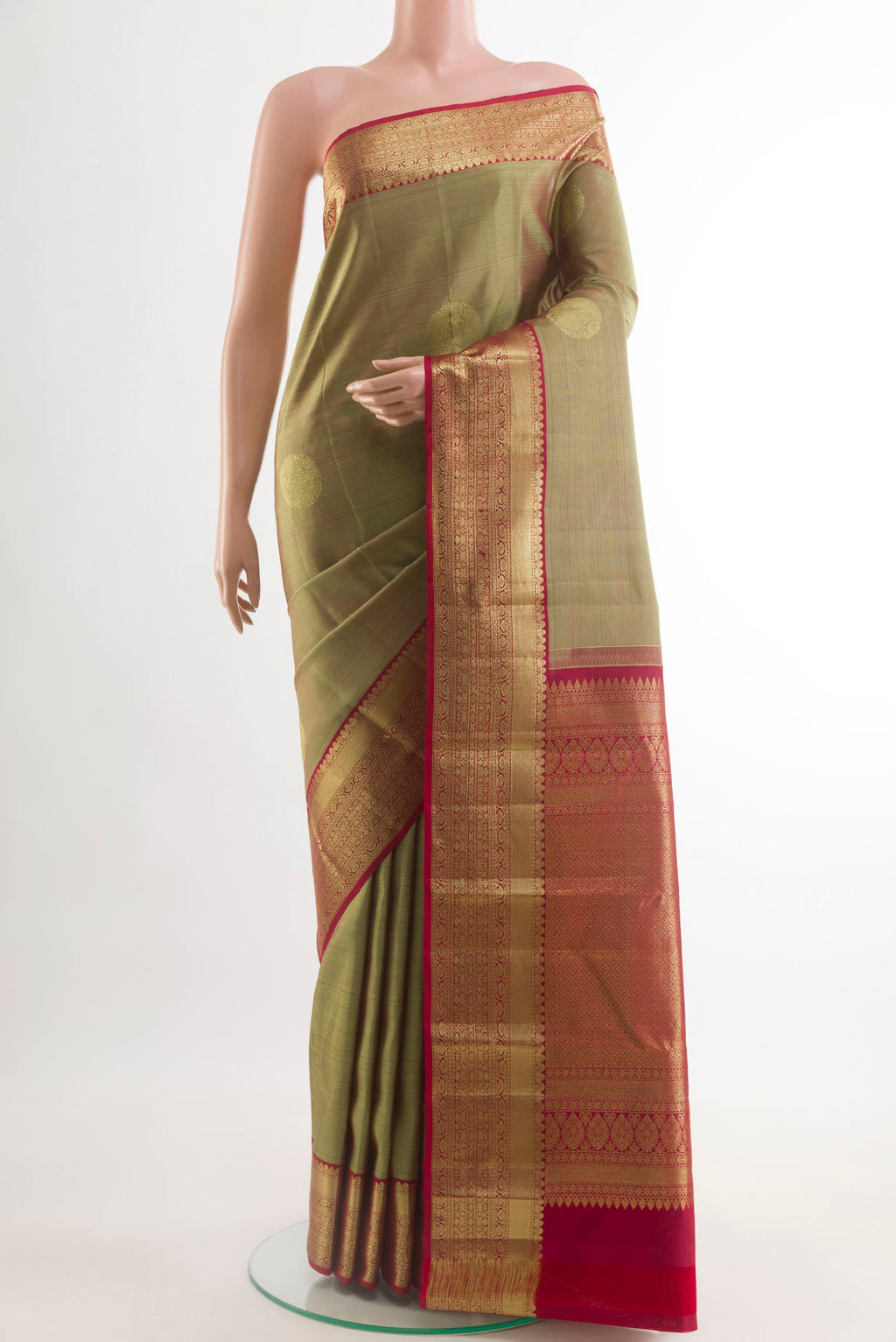 Green Kanchipuram Silk Saree with Zari Butta on the body and Zari Border.  displayed on a mannequin