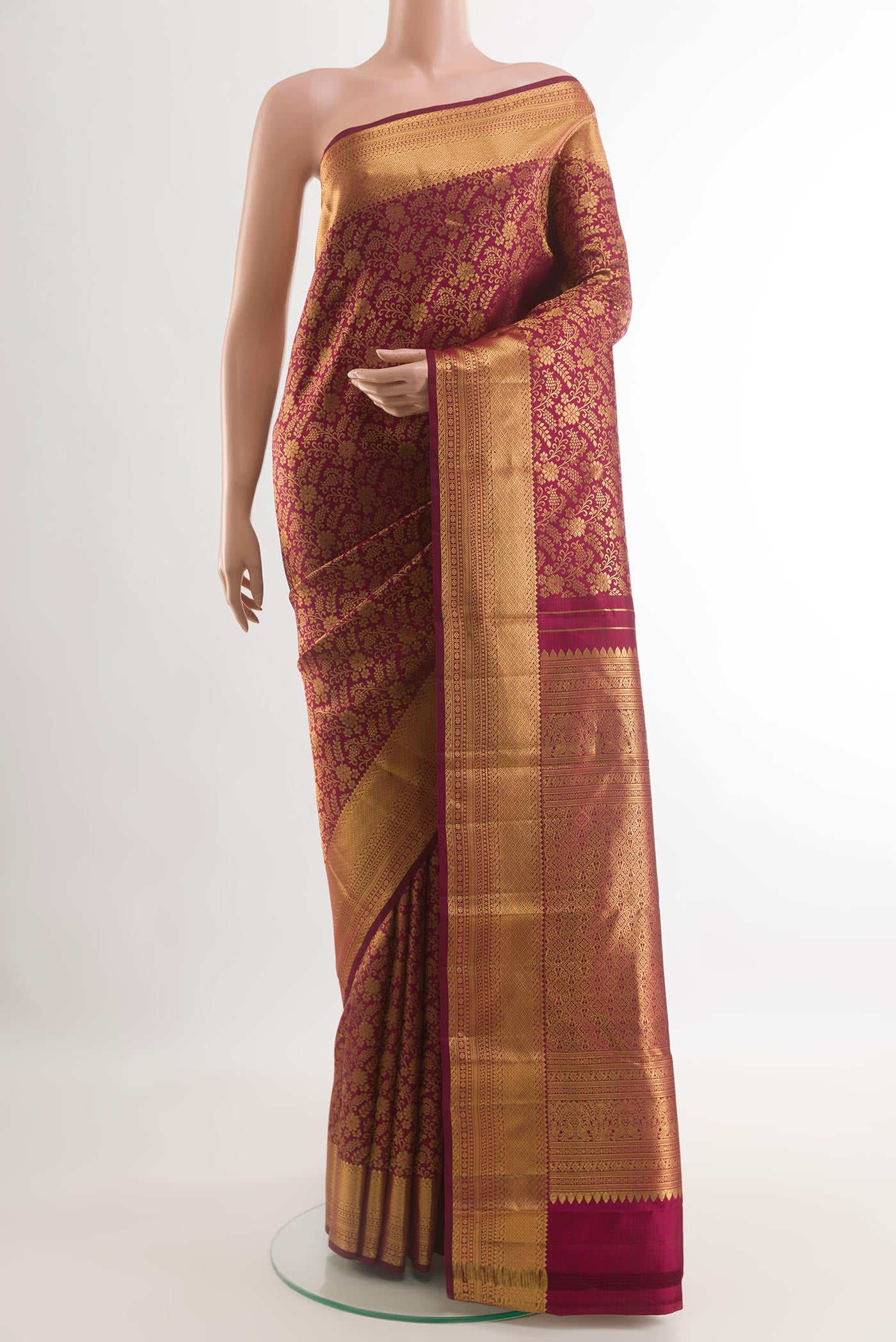 Maroon Kanjivaram Silk Saree with Zari Brocade on the body and Zari Border.  displayed on a mannequin