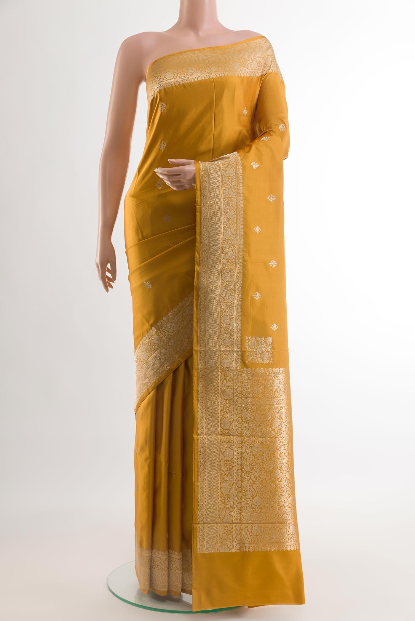 Yellow Banarasi Silk Saree with Zari Butta on the body and Zari Border.  displayed on a mannequin