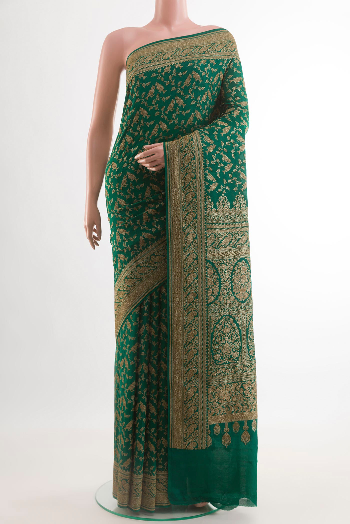 Green Banarasi Georgette Saree with Zari Brocade on the body and Zari Border.  displayed on a mannequin