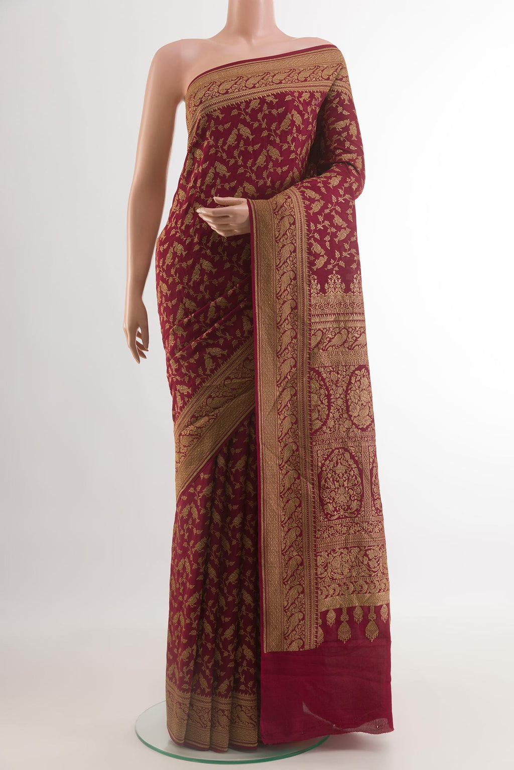 Maroon Banarasi Georgette Saree with Zari Brocade on the body and Zari Border.  displayed on a mannequin