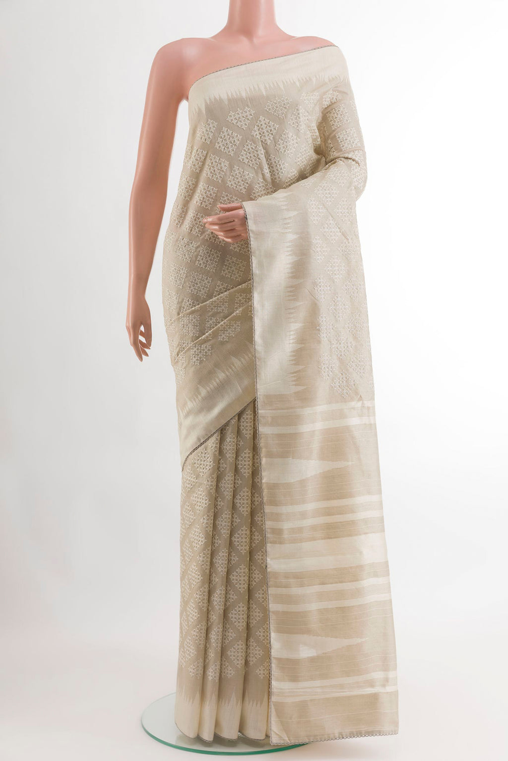 Off White Tussar Silk Saree with Embroidery on the body and Embroidery Border.  displayed on a mannequin