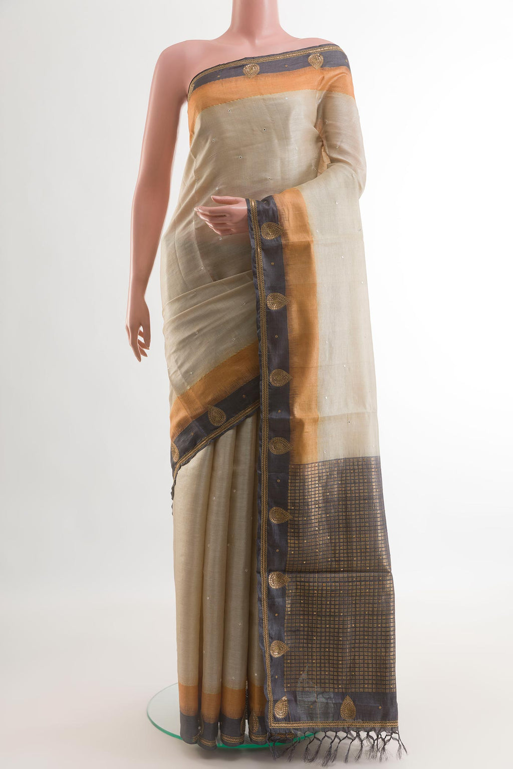 Beige Tussar Silk Saree with Embroidery on the body and Embroidery Border.  displayed on a mannequin