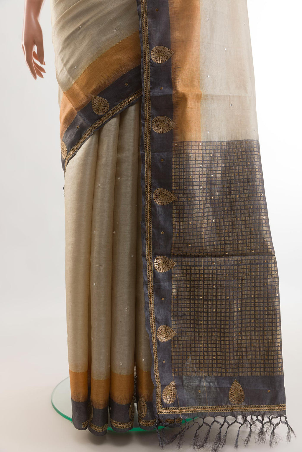 Pleats and pallu of Beige Tussar Silk Saree with Embroidery on the body and Embroidery Border. 