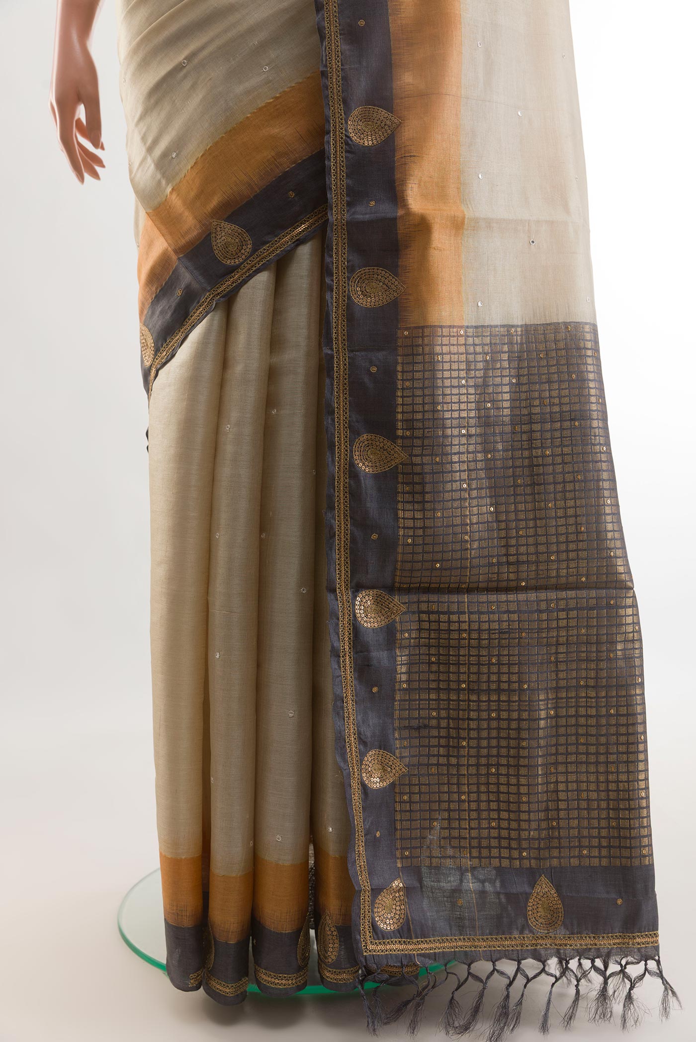 Pleats and pallu of Beige Tussar Silk Saree with Embroidery on the body and Embroidery Border. 