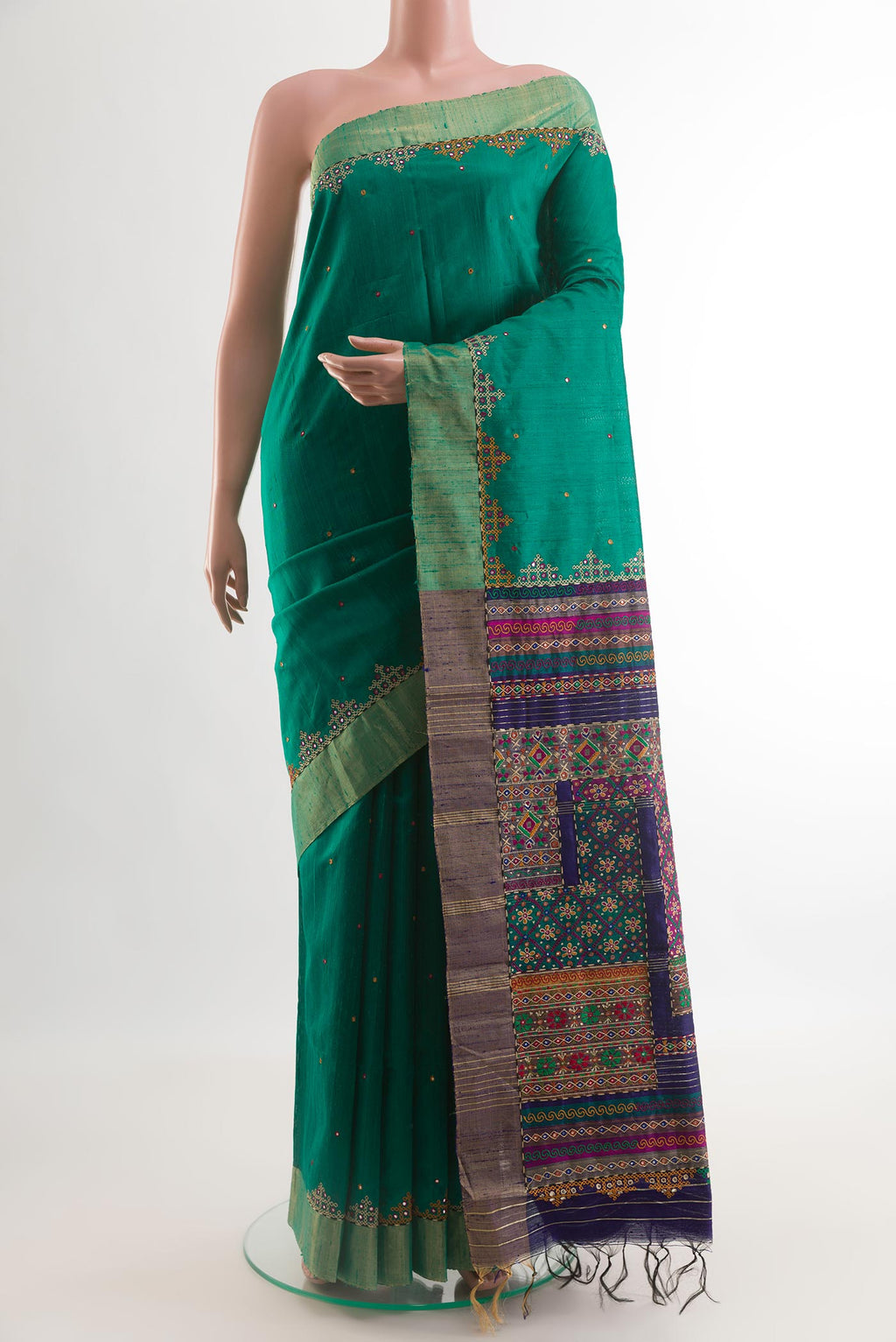 Green Tussar Silk Saree with Embroidery on the body and Embroidery Border.  displayed on a mannequin