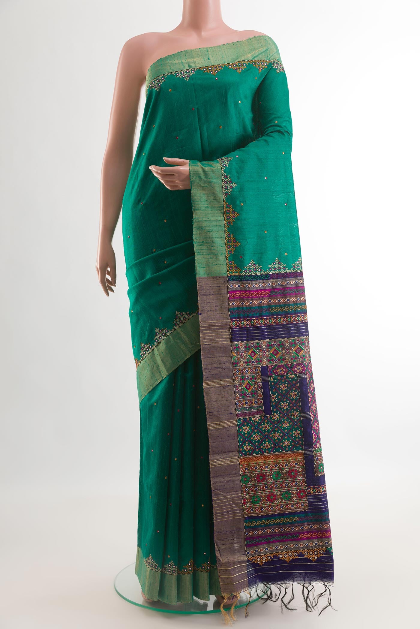Green Tussar Silk Saree with Embroidery on the body and Embroidery Border.  displayed on a mannequin