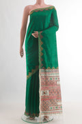Pure Silk Green Raw Saree with Embroidery on the body and Embroidery Border.  displayed on a mannequin