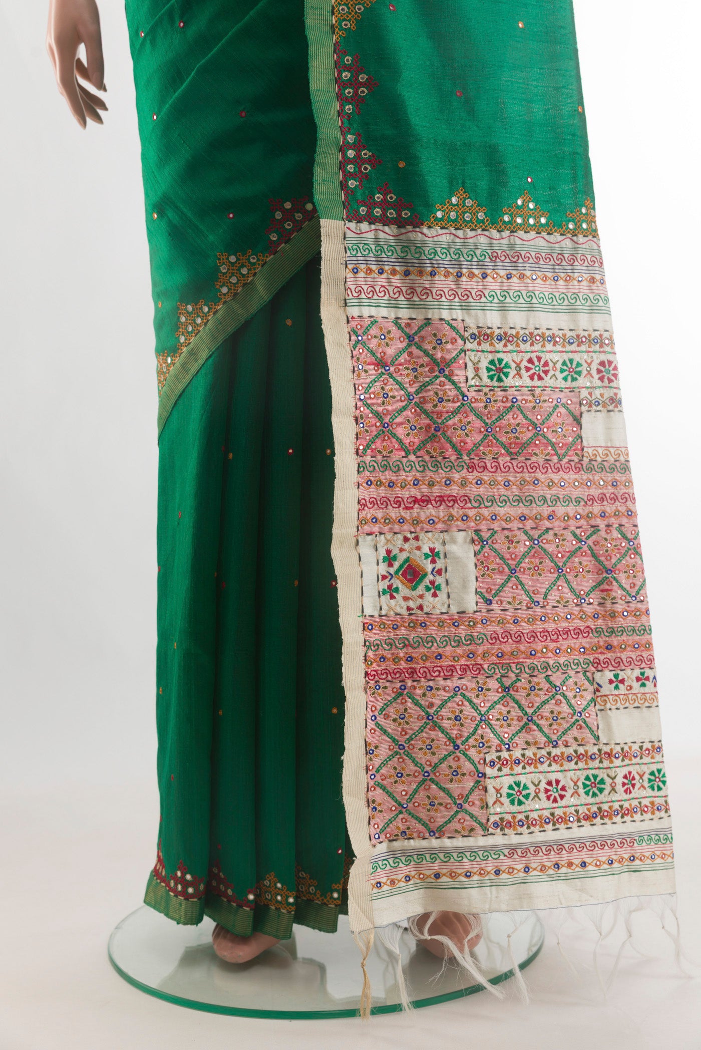 Pleats and pallu of Pure Silk Green Raw Saree with Embroidery on the body and Embroidery Border. 