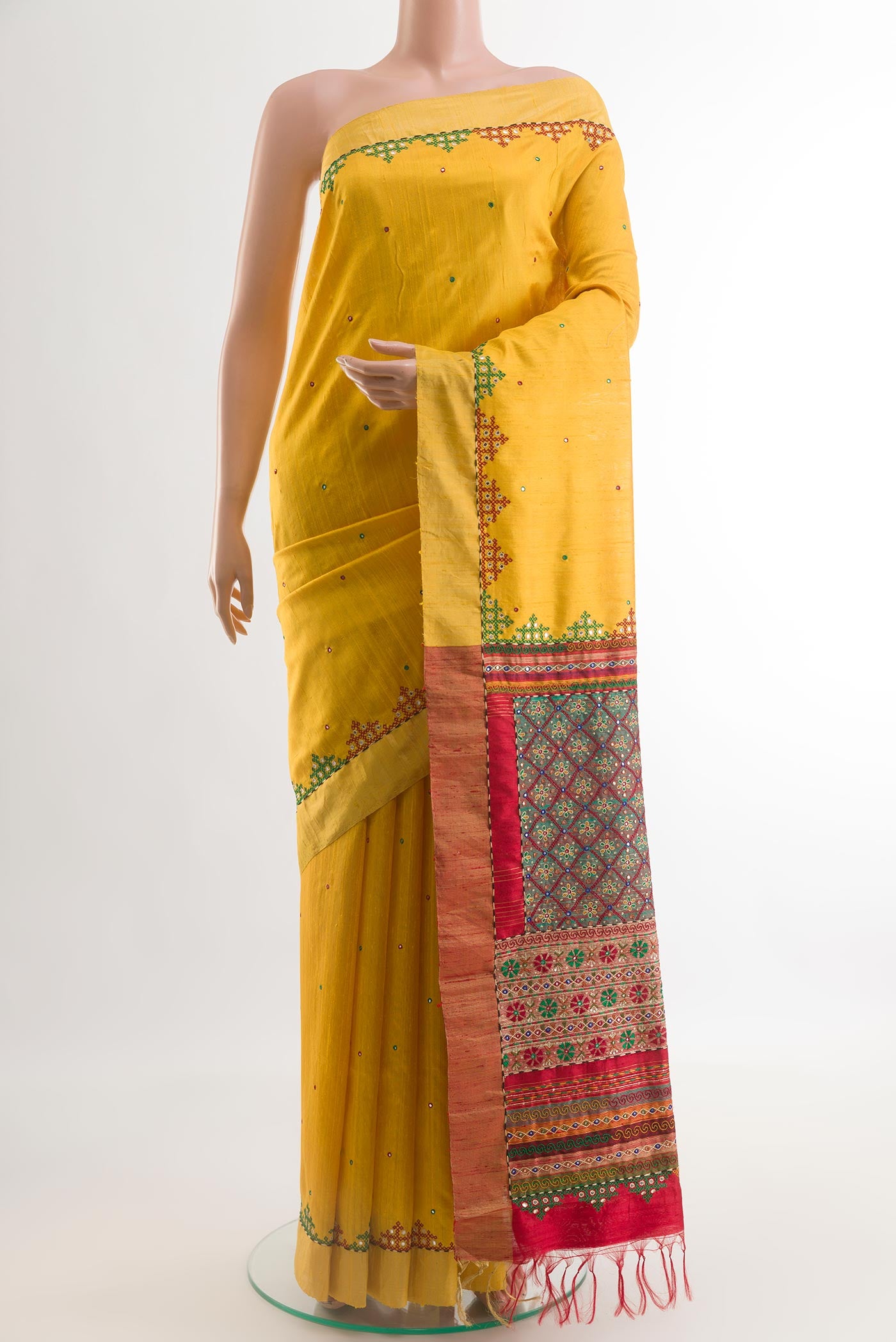 Yellow Tussar Silk Saree with Embroidery on the body and Embroidery Border.  displayed on a mannequin