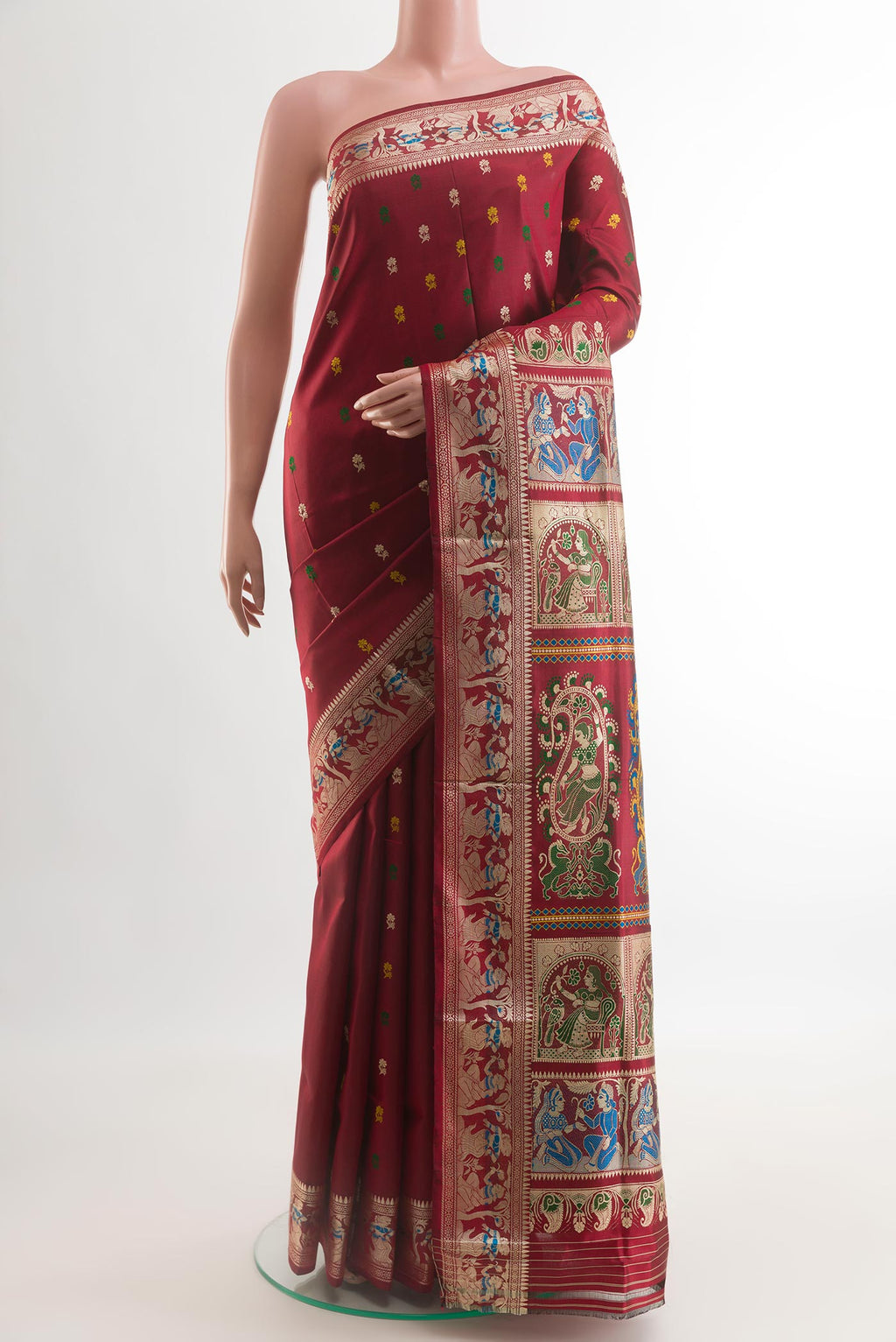 Maroon Baluchari Silk Saree with Zari And Thread Butta on the body and Zari Border.  displayed on a mannequin