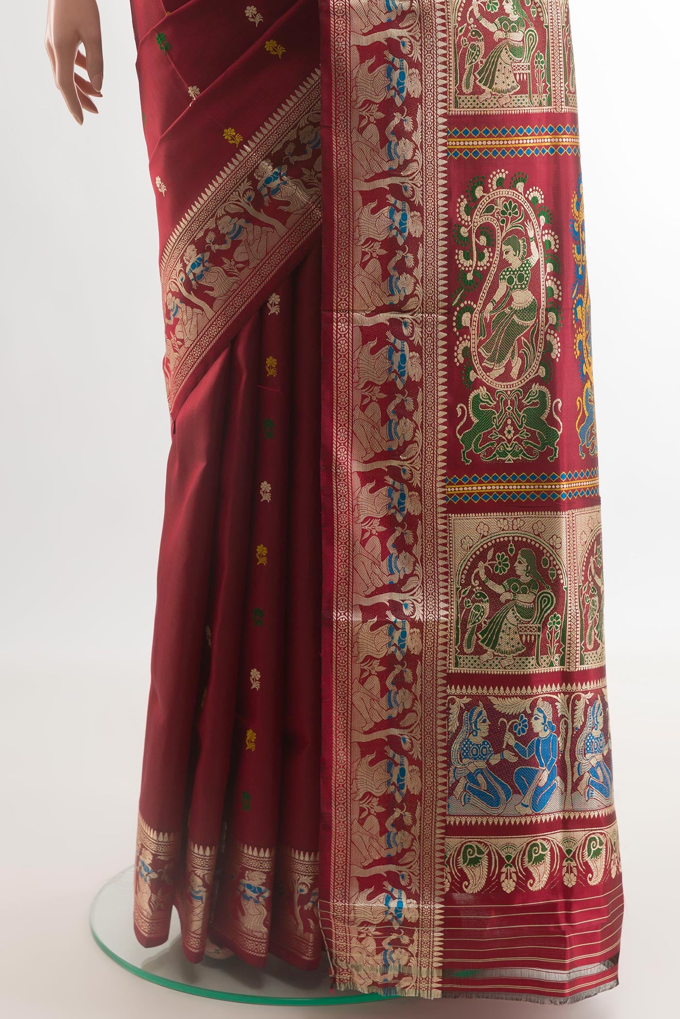 Pleats and pallu of Maroon Baluchari Silk Saree with Zari And Thread Butta on the body and Zari Border. 