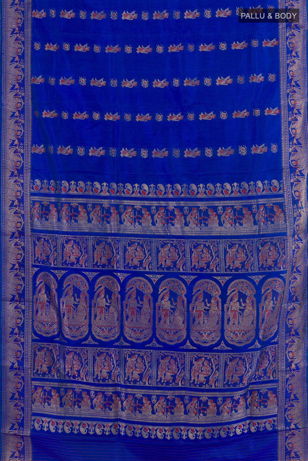 Flat view of Royal Blue Baluchari Silk Saree with Zari And Thread Butta on the body and Zari Border. 