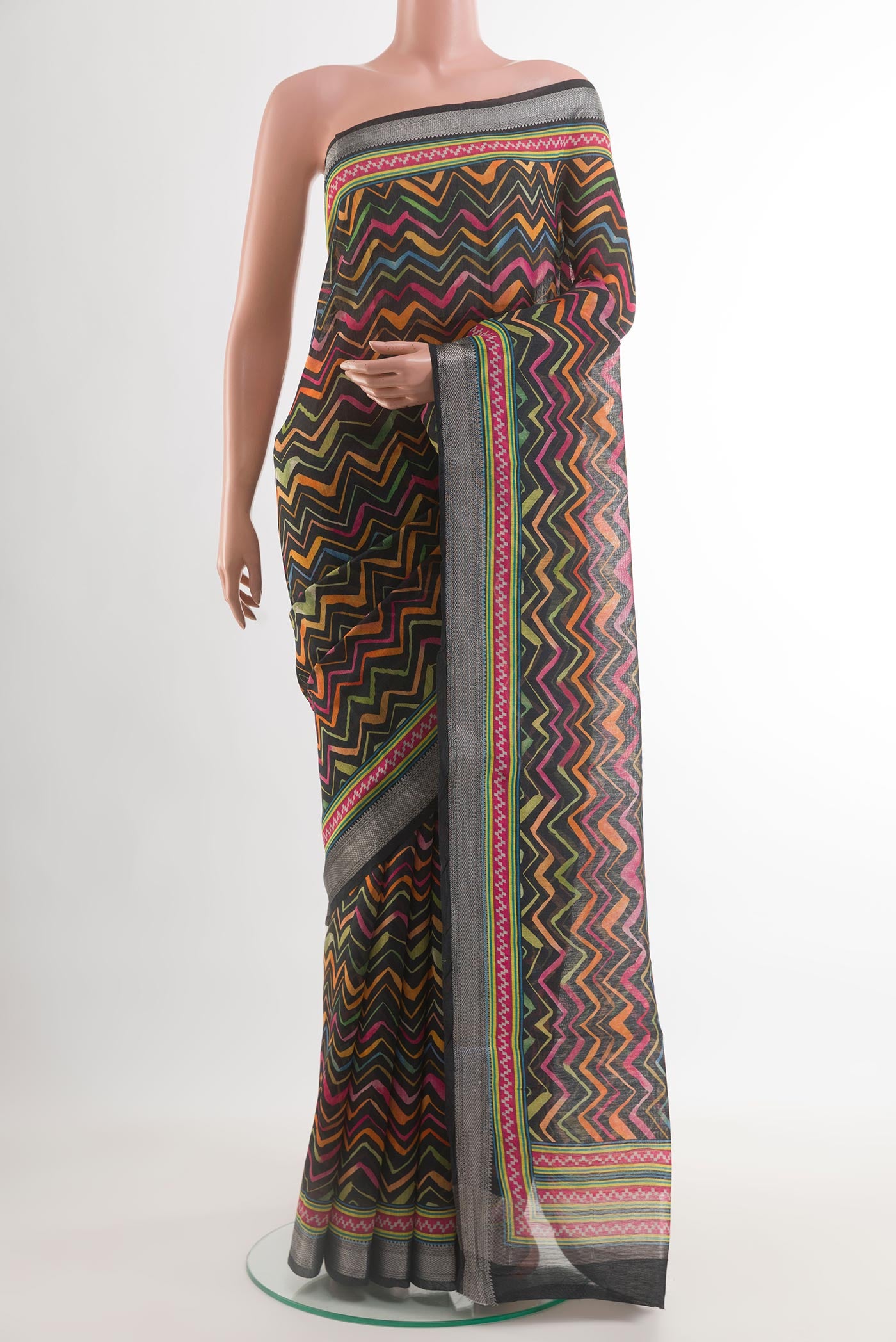 Black Tussar Silk Saree with Printed design on the body and Zari Border.  displayed on a mannequin