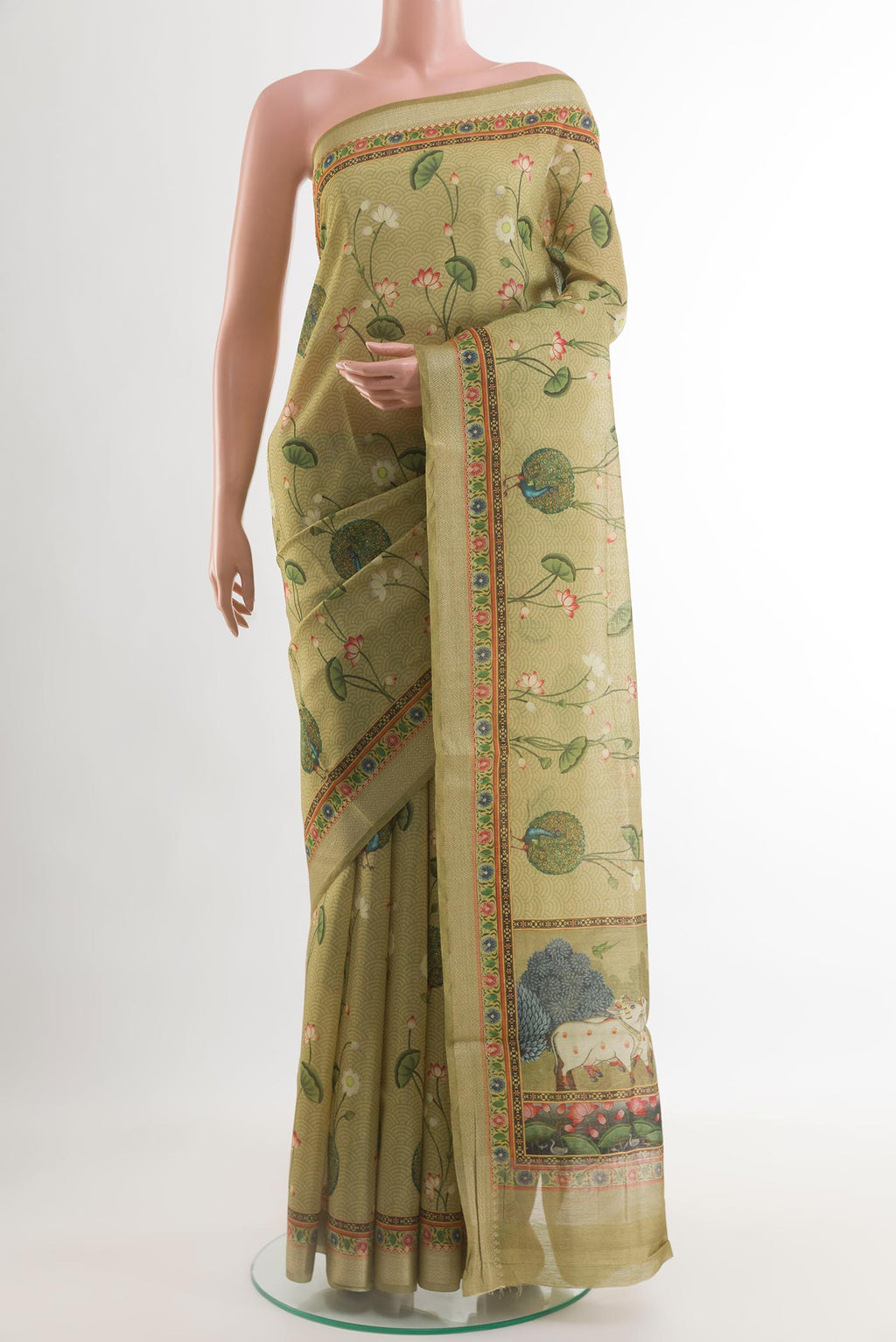 Green Tussar Silk Saree with Printed design on the body and Zari Border.  displayed on a mannequin