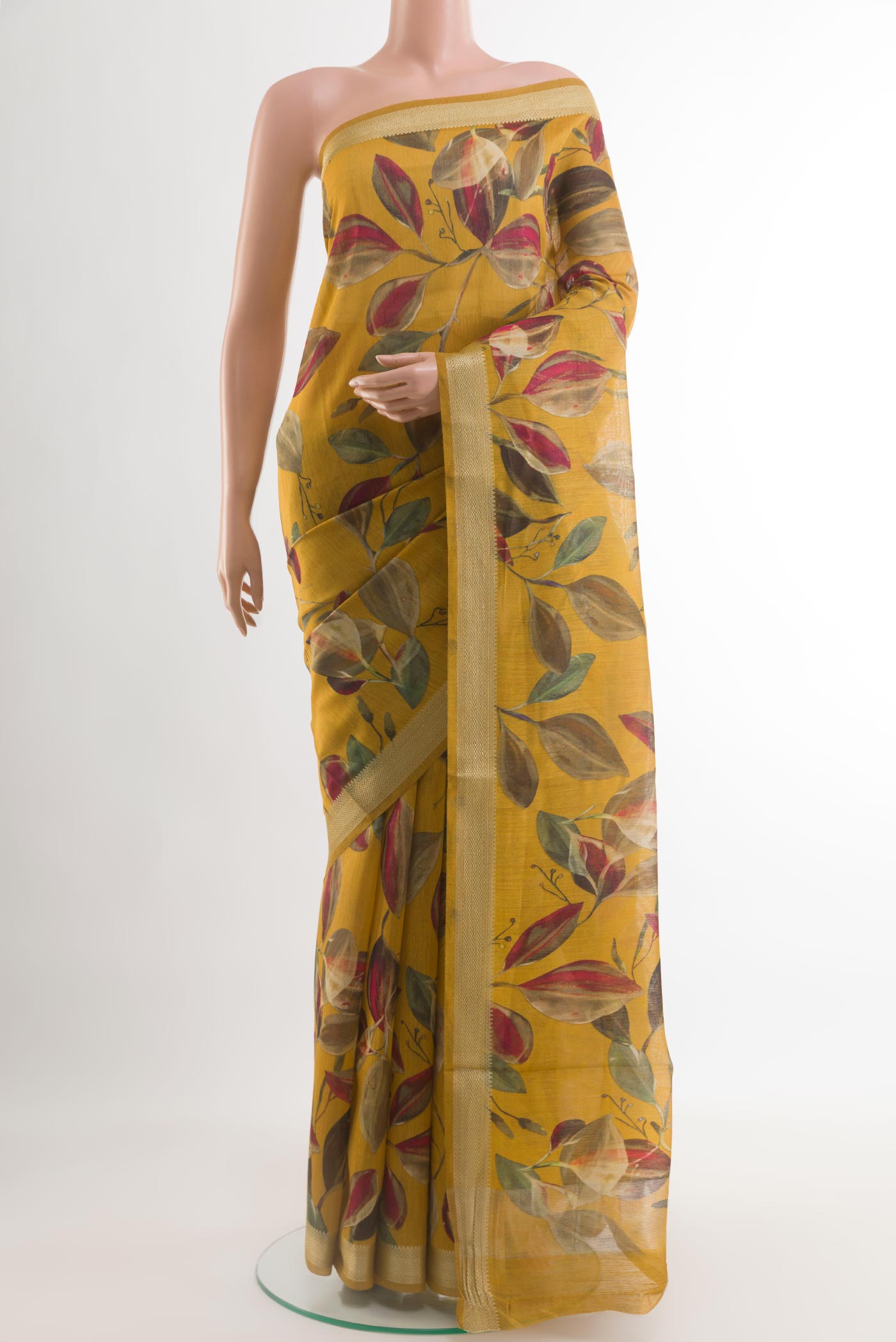 Mustard Tussar Saree with Printed design on the body and Zari Border.  displayed on a mannequin