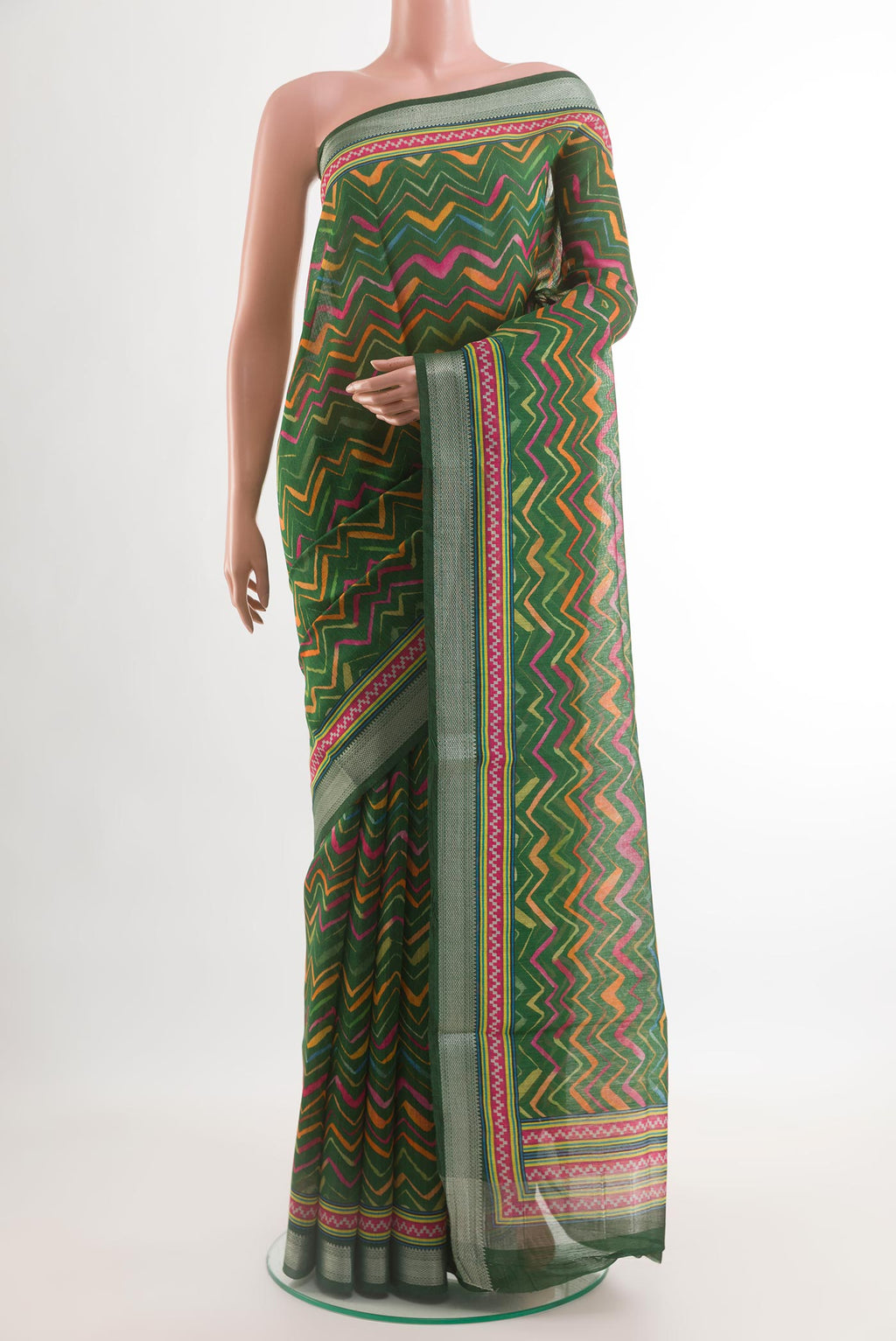 Green Tussar Silk Saree with Printed design on the body and Zari Border.  displayed on a mannequin