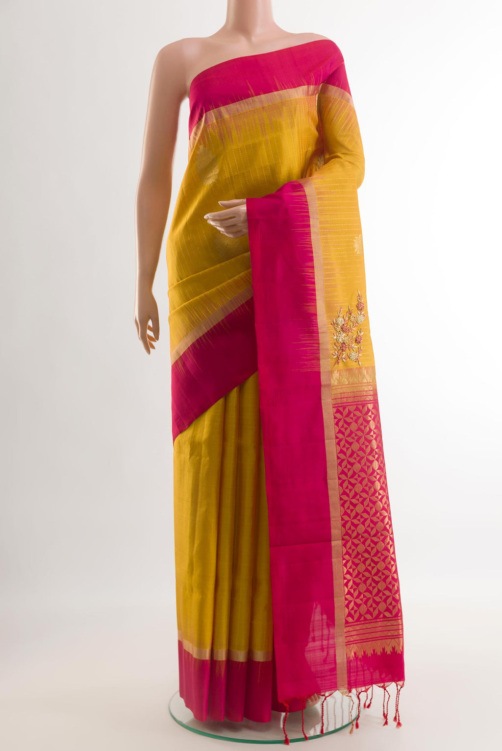 Yellow Soft Silk Saree with Zari Butta on the body and Zari Border.  displayed on a mannequin