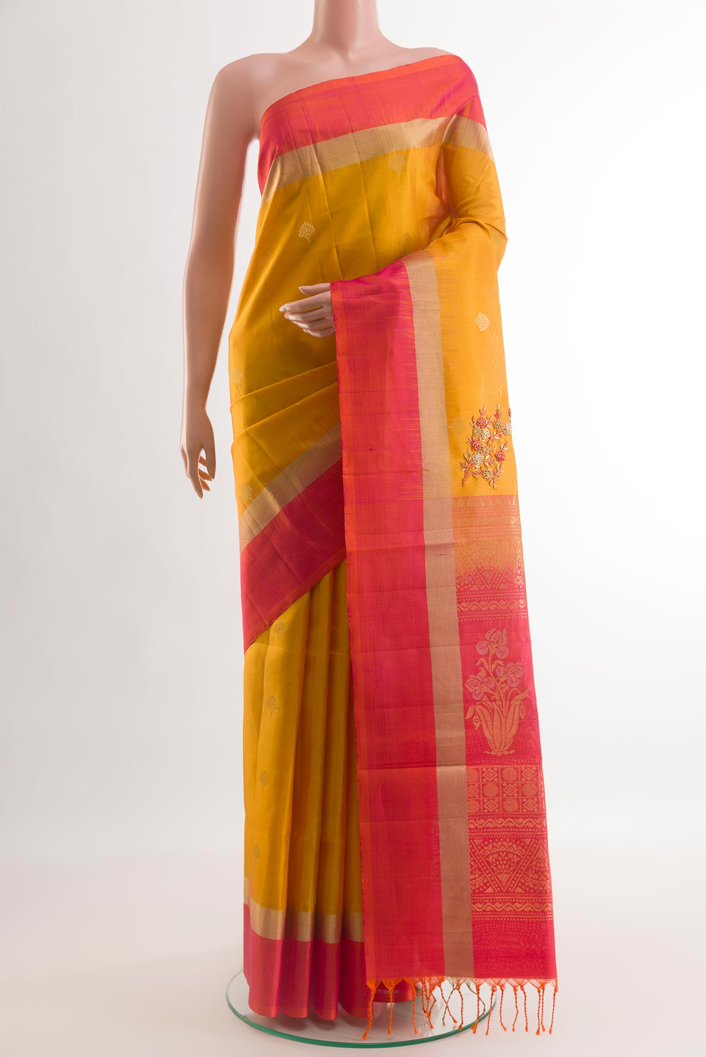Yellow Soft Silk Saree with Zari Butta on the body and Zari Border.  displayed on a mannequin