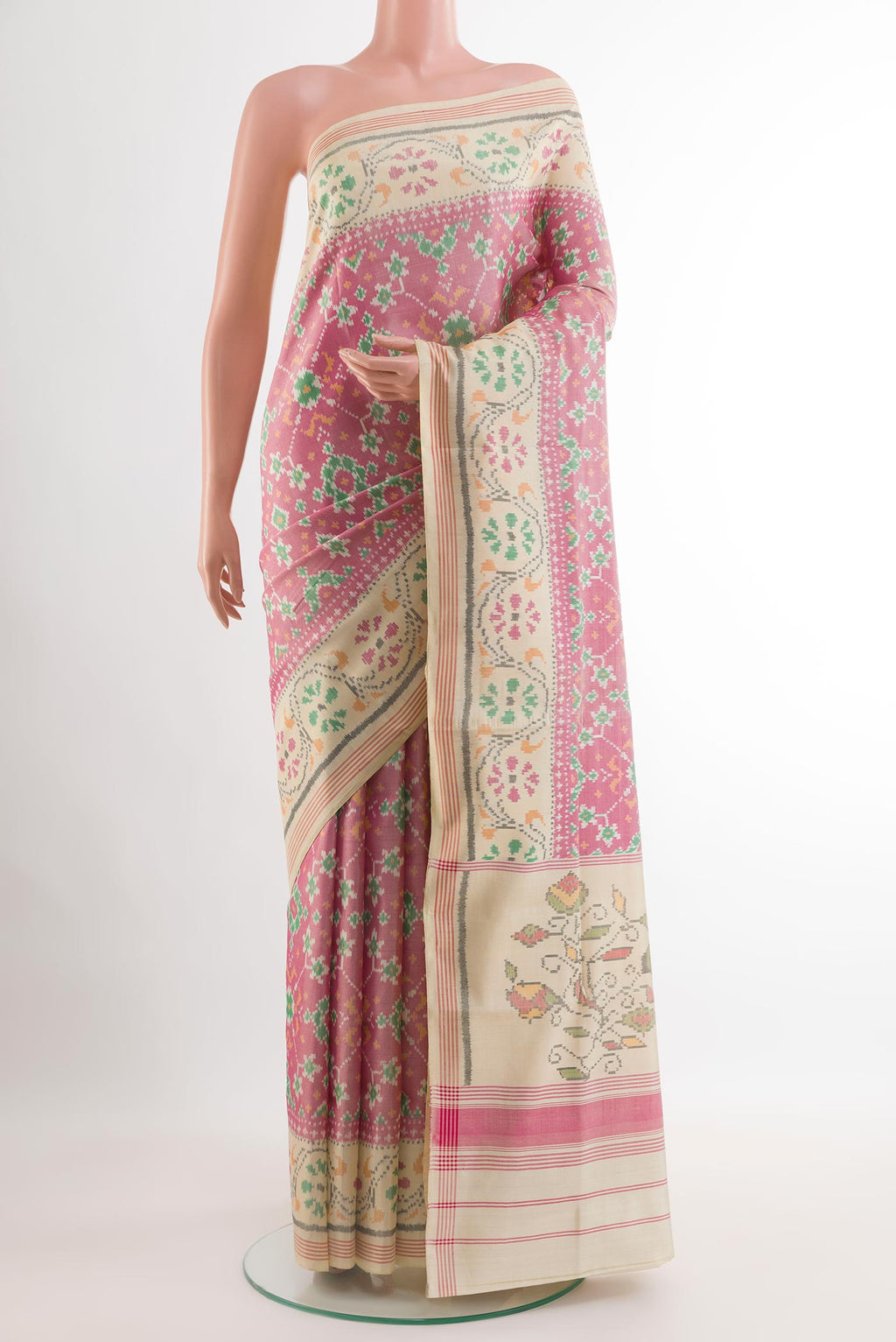Off White Rajkot Patola Silk Saree with Ikat design on the body and Zari Border.  displayed on a mannequin
