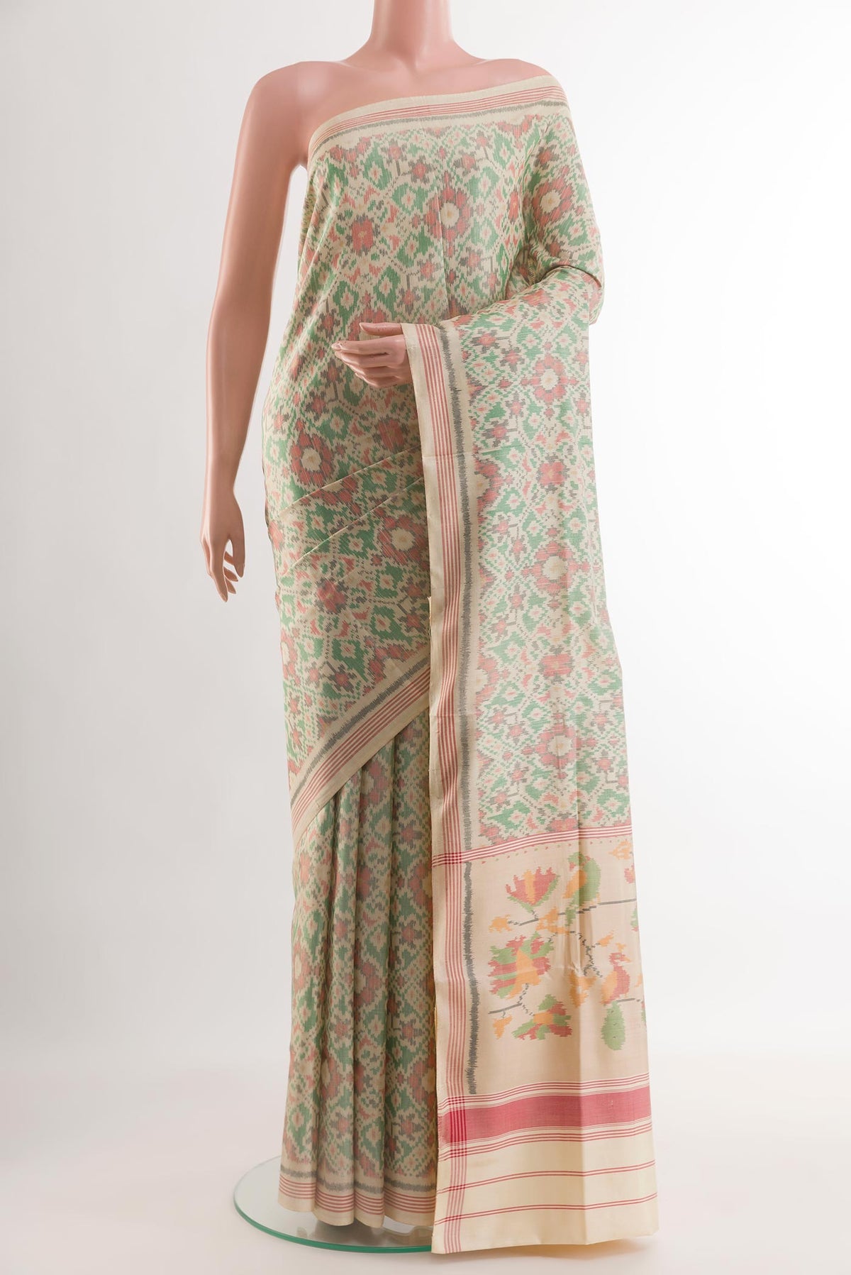 Cream Rajkot Patola Silk Saree with Pure Ikat on the body and Zari Border.  displayed on a mannequin