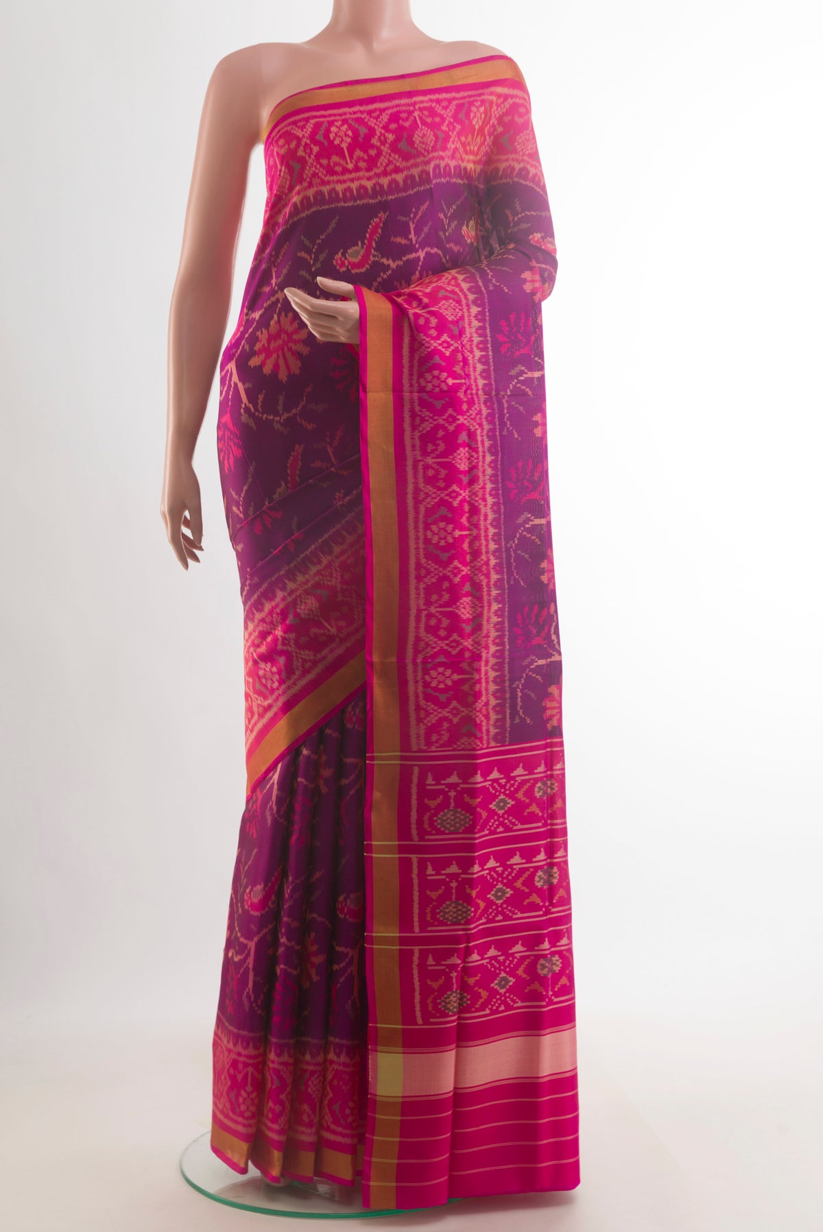 Pure Silk Purple Rajkot Patola Saree with Pure Ikat on the body and Zari Border.  displayed on a mannequin