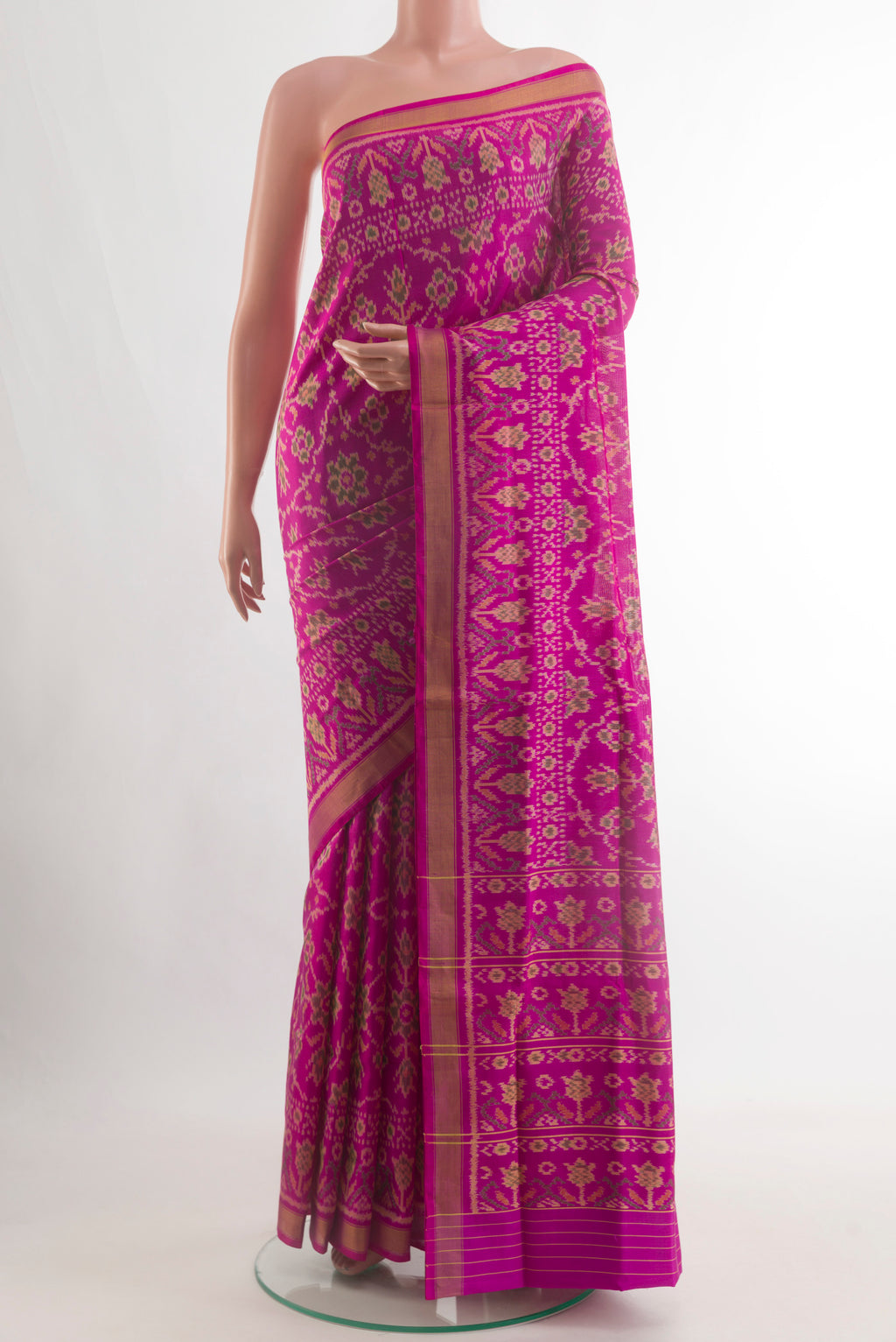 Magenta Rajkot Patola Silk Saree with Pure Ikat on the body and Zari Border.  displayed on a mannequin