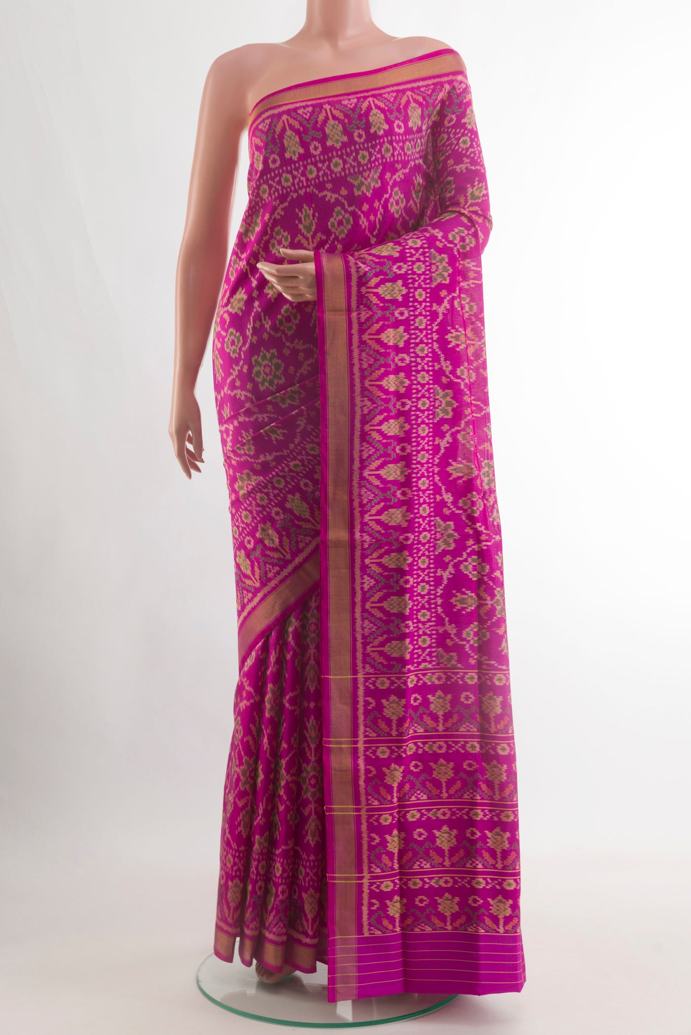 Magenta Rajkot Patola Silk Saree with Pure Ikat on the body and Zari Border.  displayed on a mannequin
