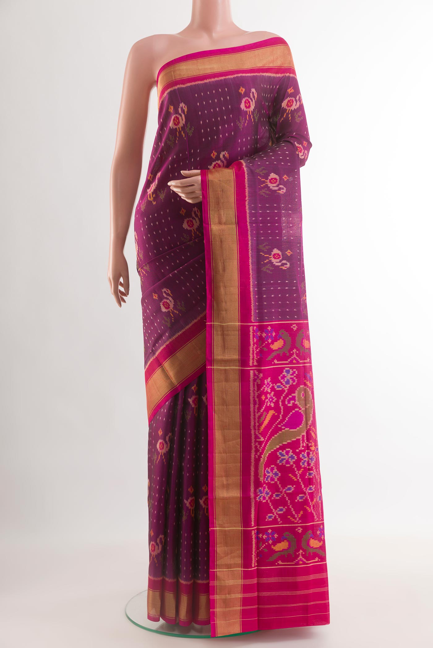 Purple Rajkot Patola Silk Saree with Pure Ikat on the body and Zari Border.  displayed on a mannequin