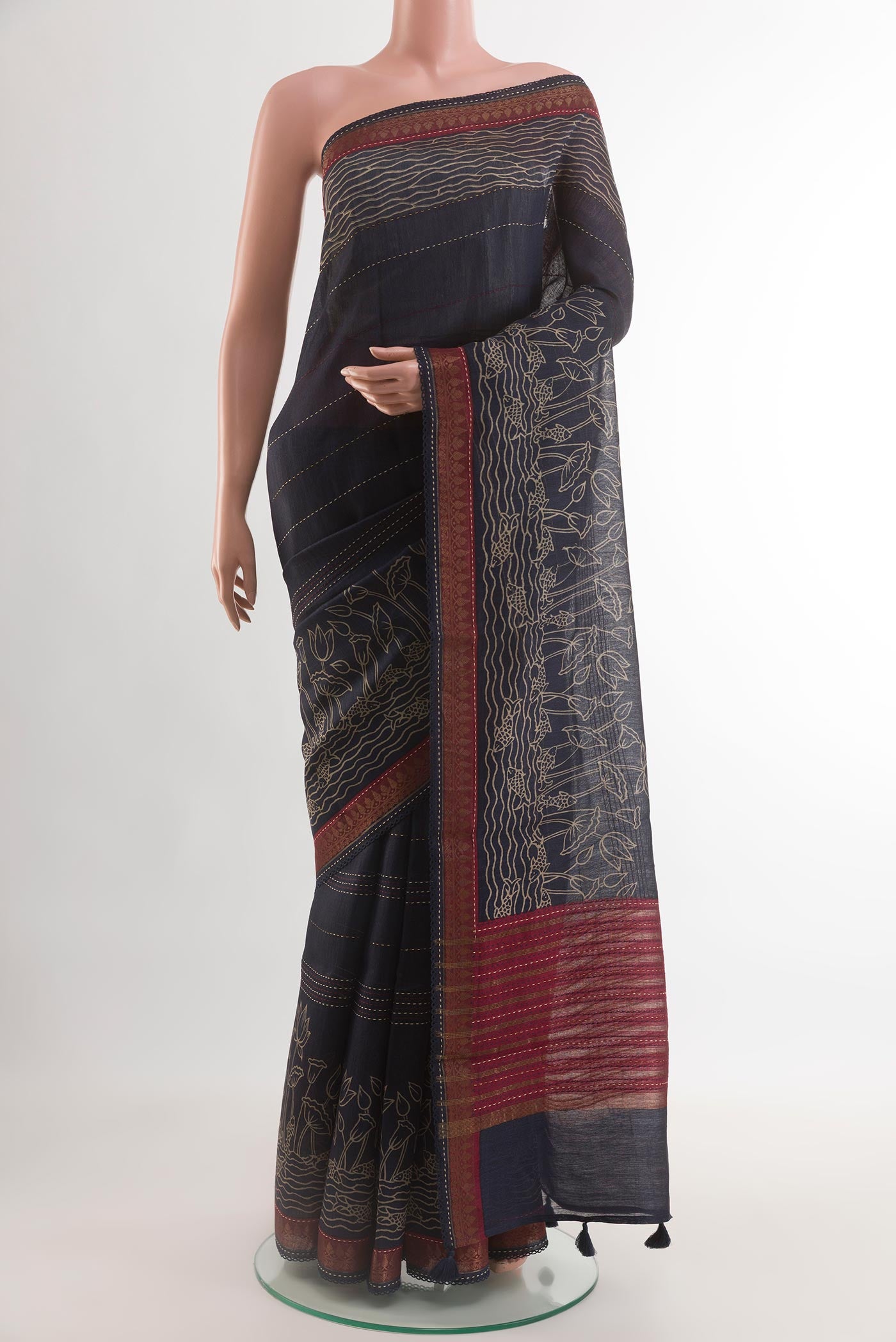 Navy Blue Tussar Silk Saree with Embroidery on the body and Zari Border.  displayed on a mannequin