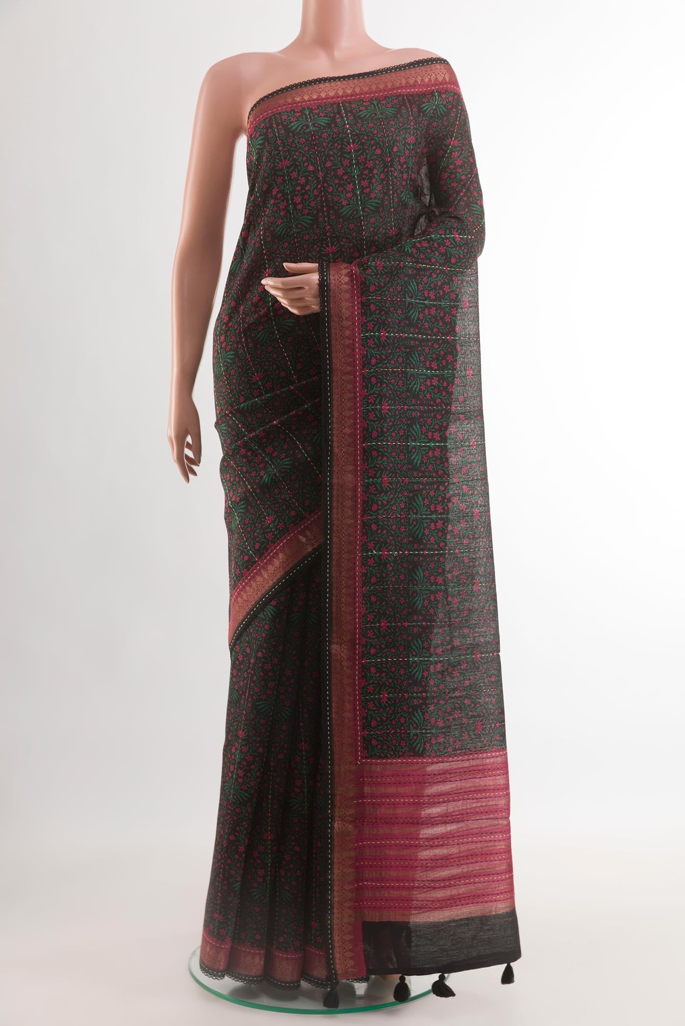 Black Tussar Silk Saree with Printed design on the body and Zari Border.  displayed on a mannequin