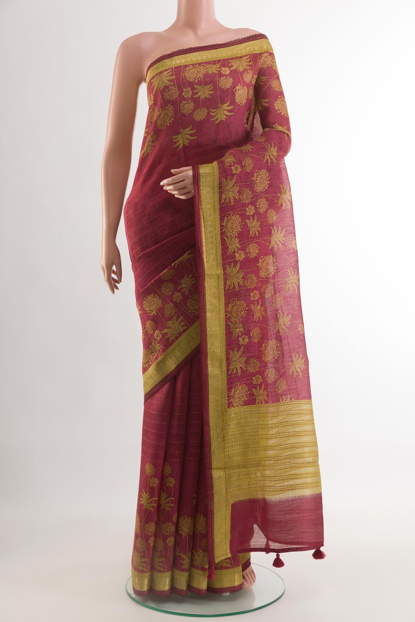 Maroon Tussar Silk Saree with Stripes on the body and Zari Border.  displayed on a mannequin