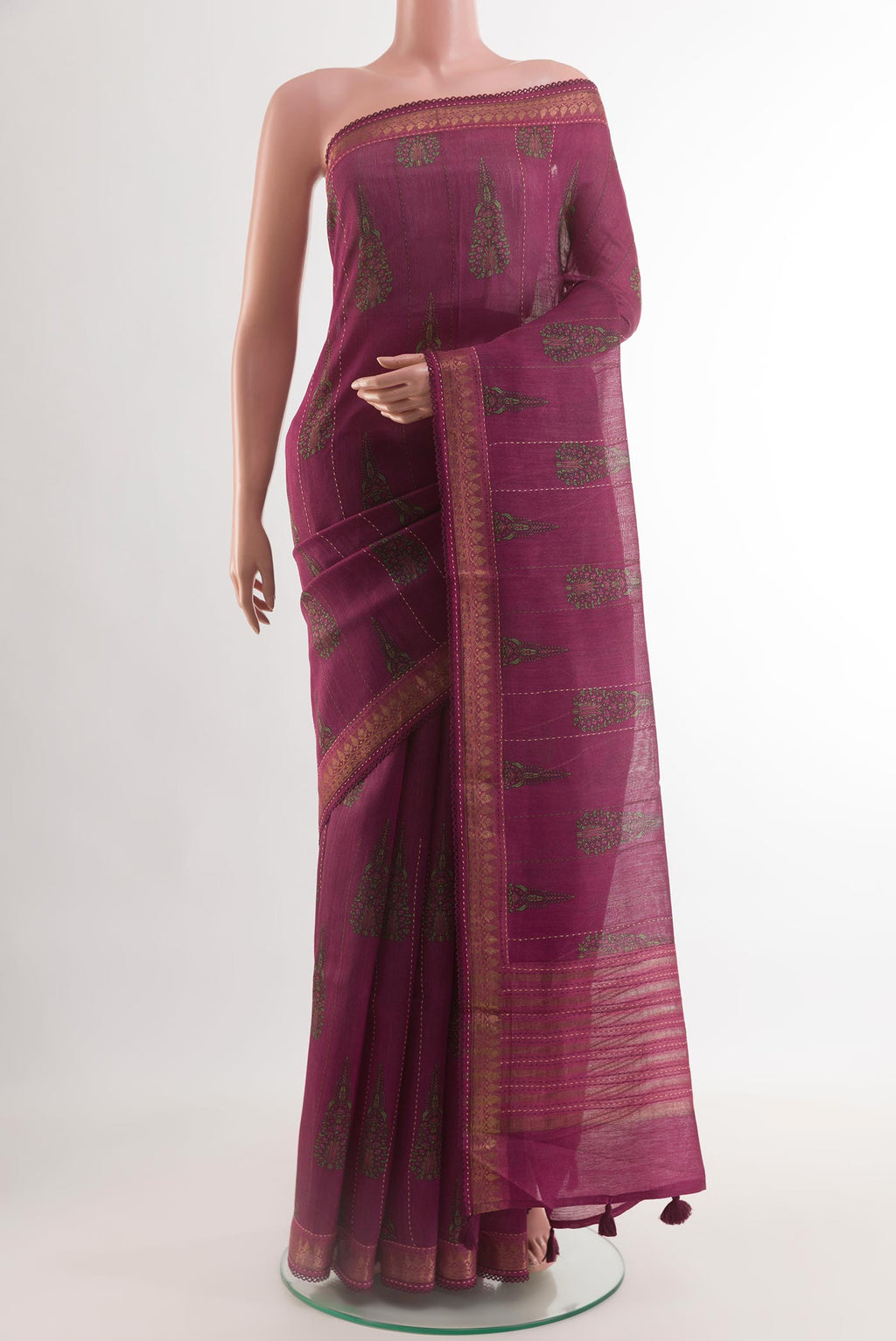 Magenta Tussar Silk Saree with Printed design on the body and Zari Border.  displayed on a mannequin