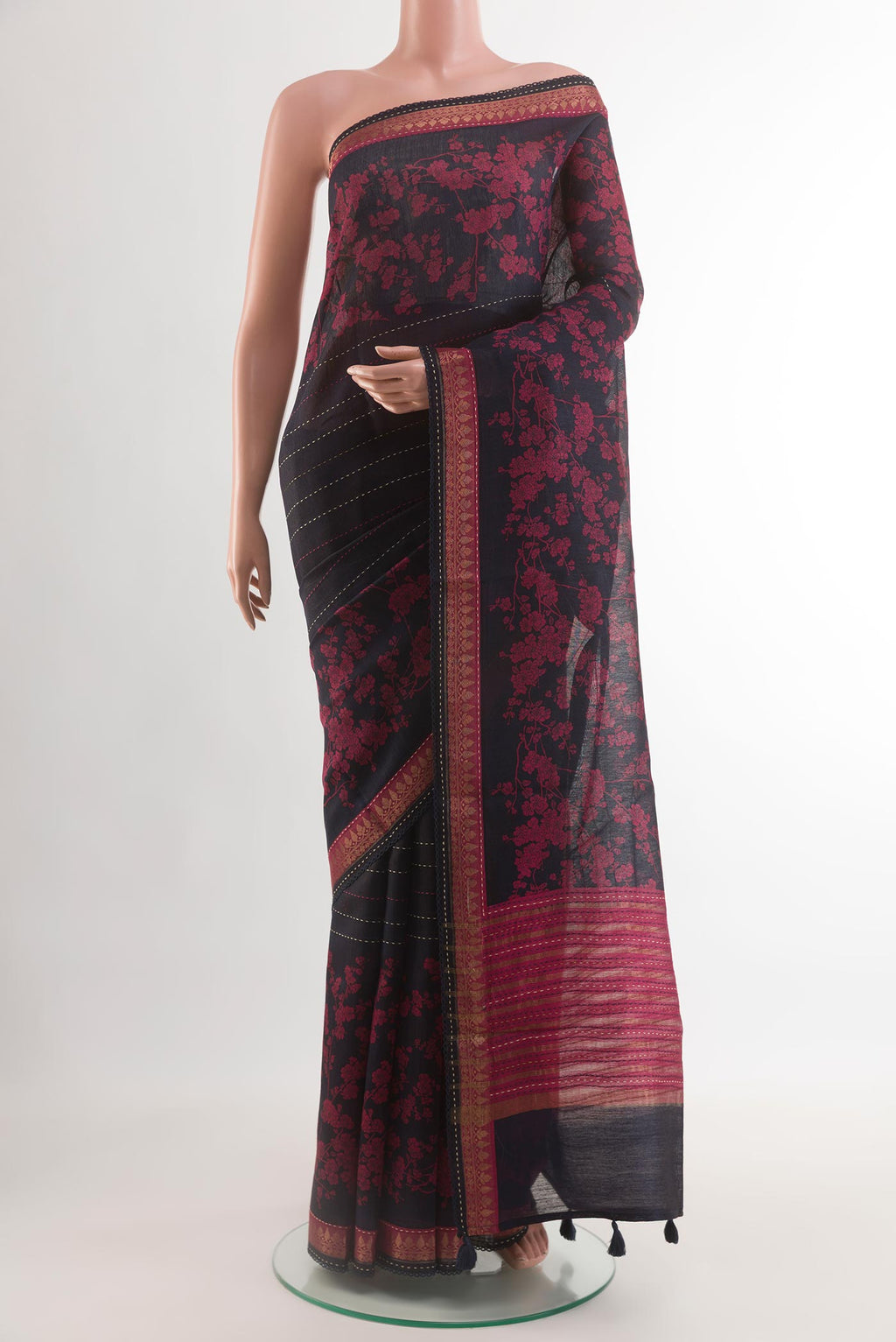 Navy Blue Tussar Silk Saree with Printed design on the body and Zari Border.  displayed on a mannequin