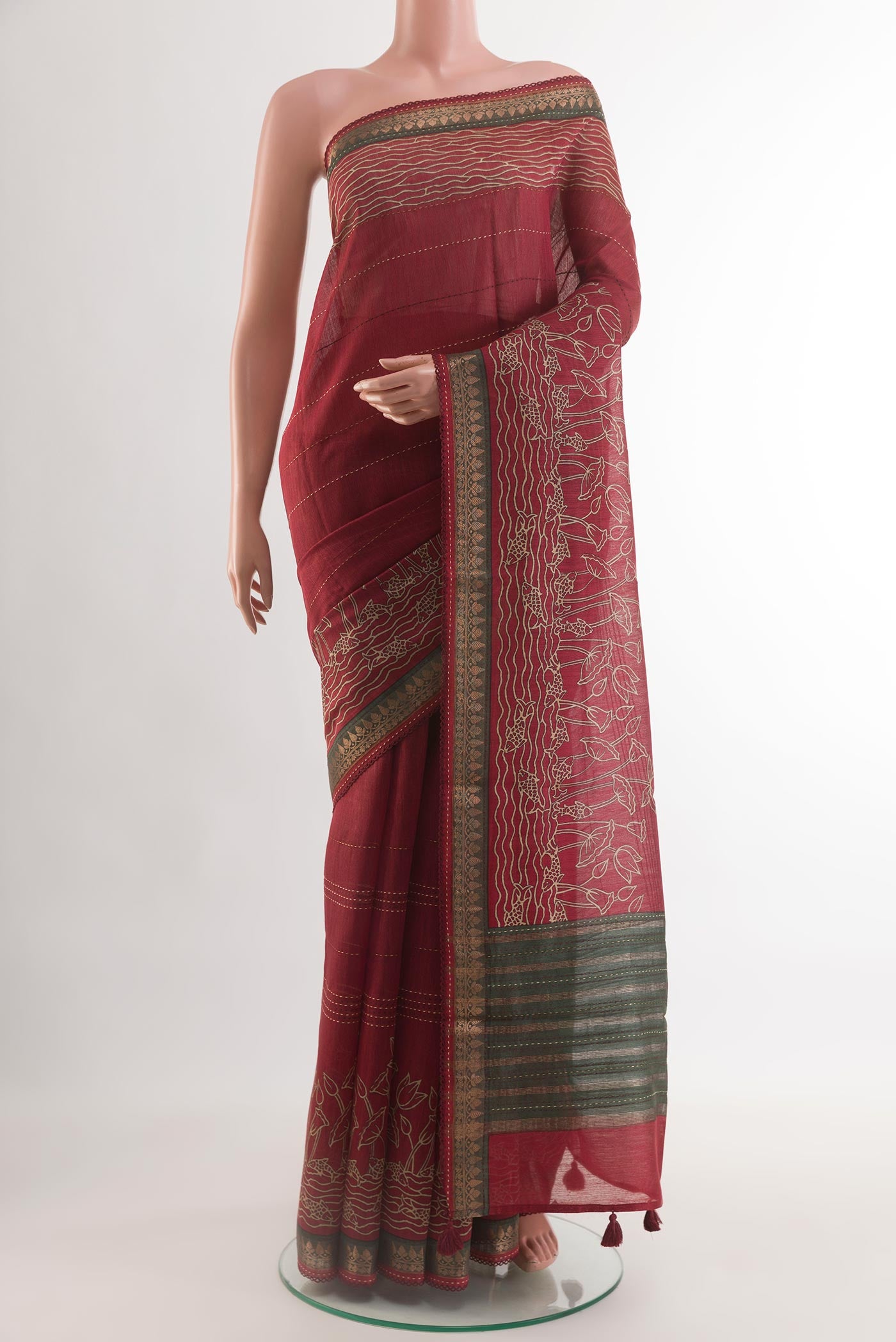 Maroon Tussar Saree with Printed design on the body and Zari Border.  displayed on a mannequin