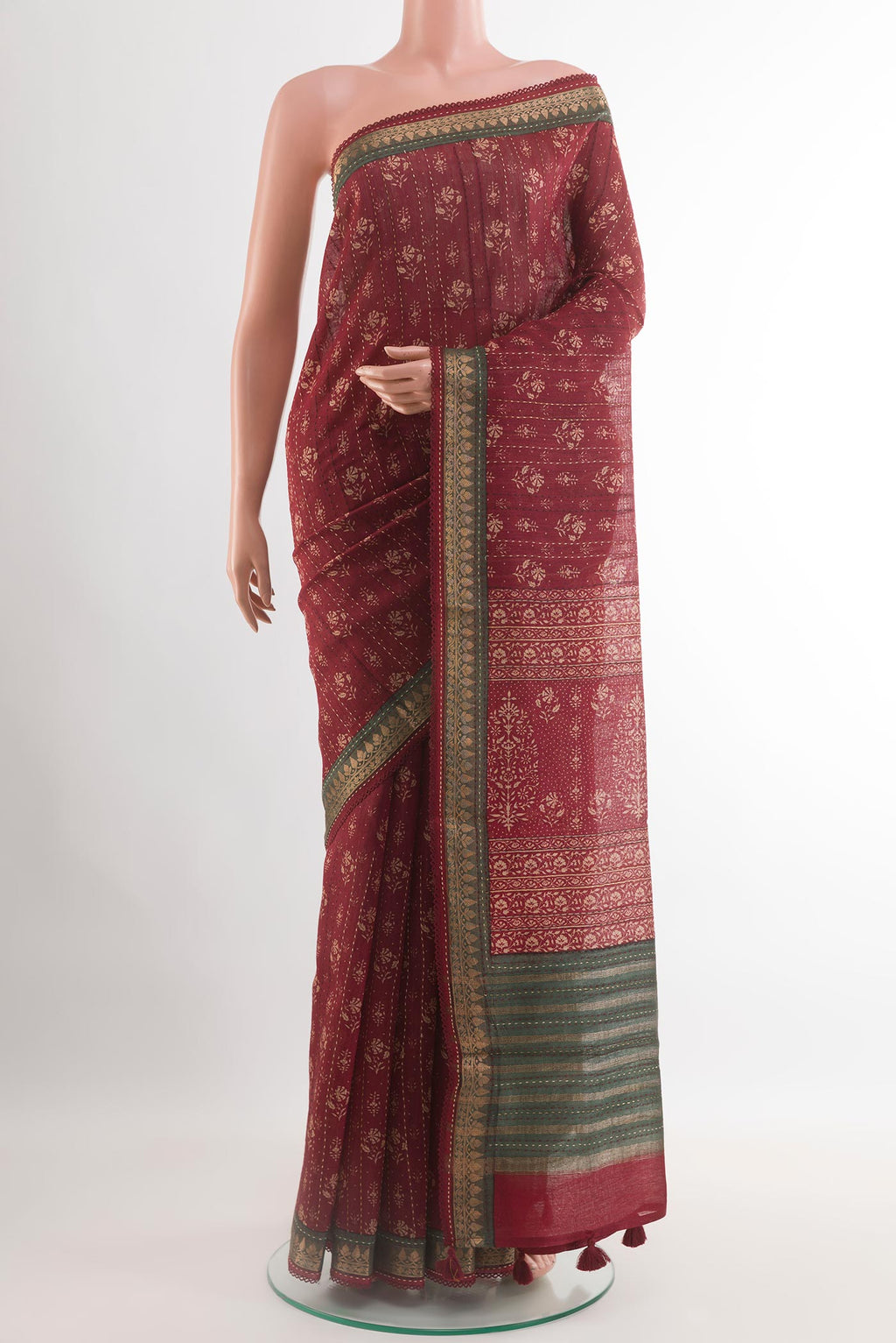 Maroon Tussar Saree with Printed design on the body and Zari Border.  displayed on a mannequin