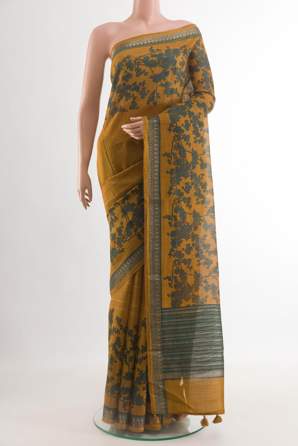 Mustard Tussar Saree with Printed design on the body and Zari Border.  displayed on a mannequin