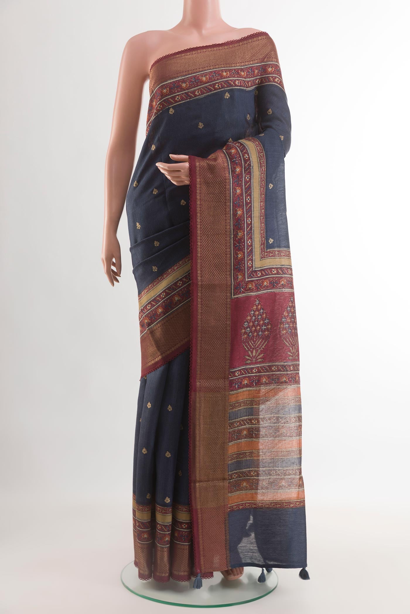 Navy Blue Tussar Silk Saree with Printed design on the body and Zari Border.  displayed on a mannequin