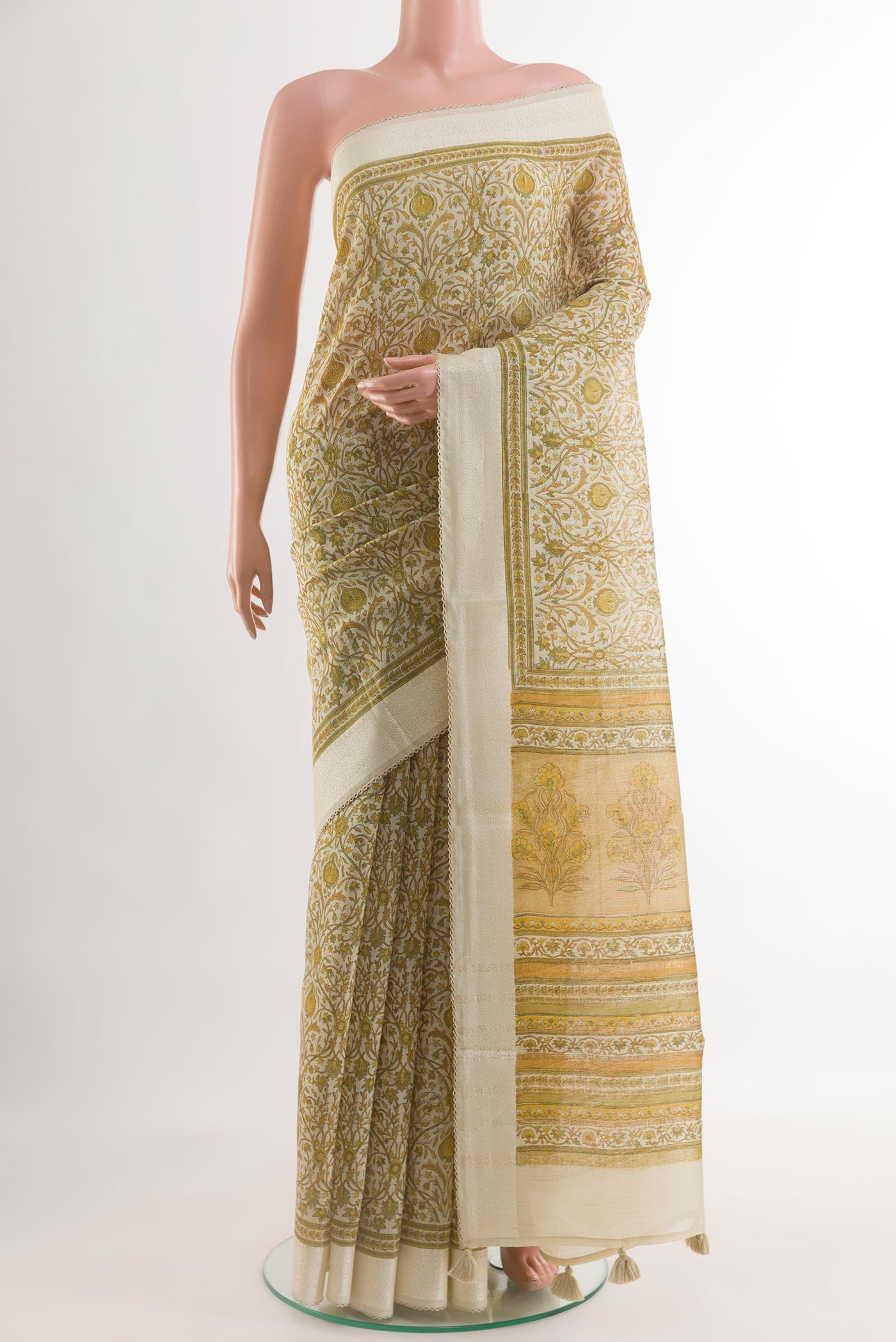 Green Tussar Saree with Printed design on the body and Zari Border.  displayed on a mannequin