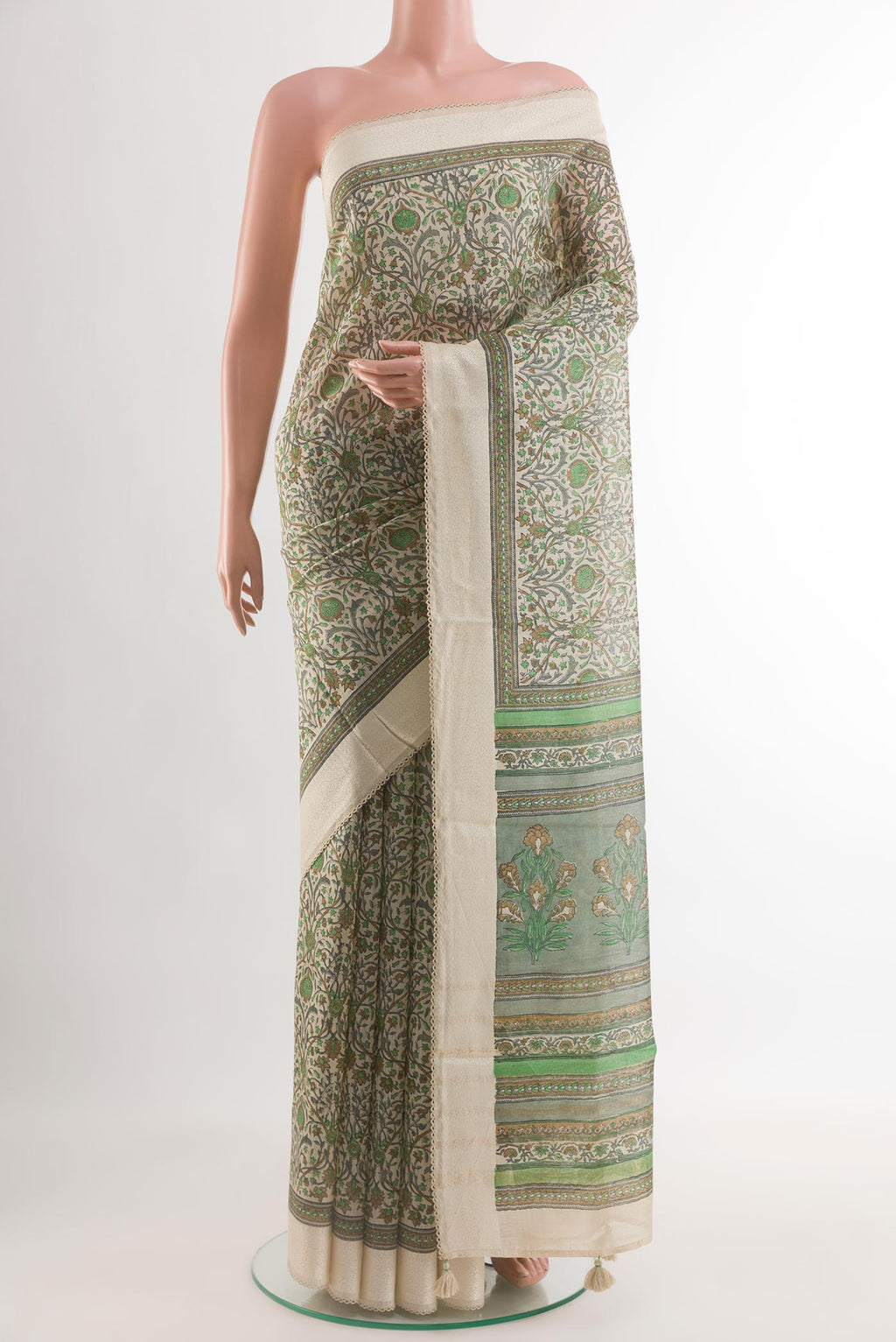 Green Tussar Silk Saree with Printed design on the body and Zari Border.  displayed on a mannequin
