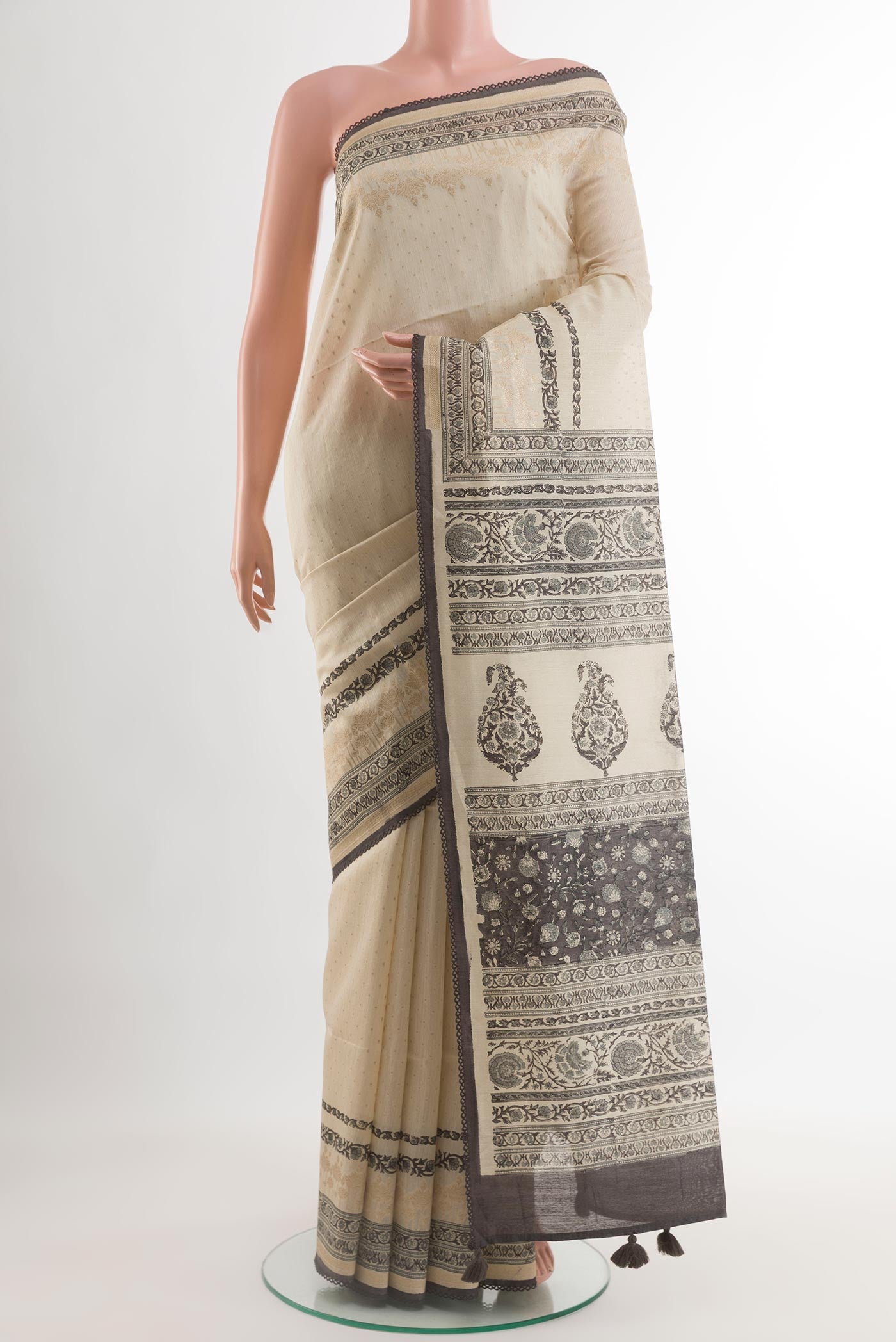 Cream Tussar Silk Saree with Printed design on the body and Printed Border.  displayed on a mannequin