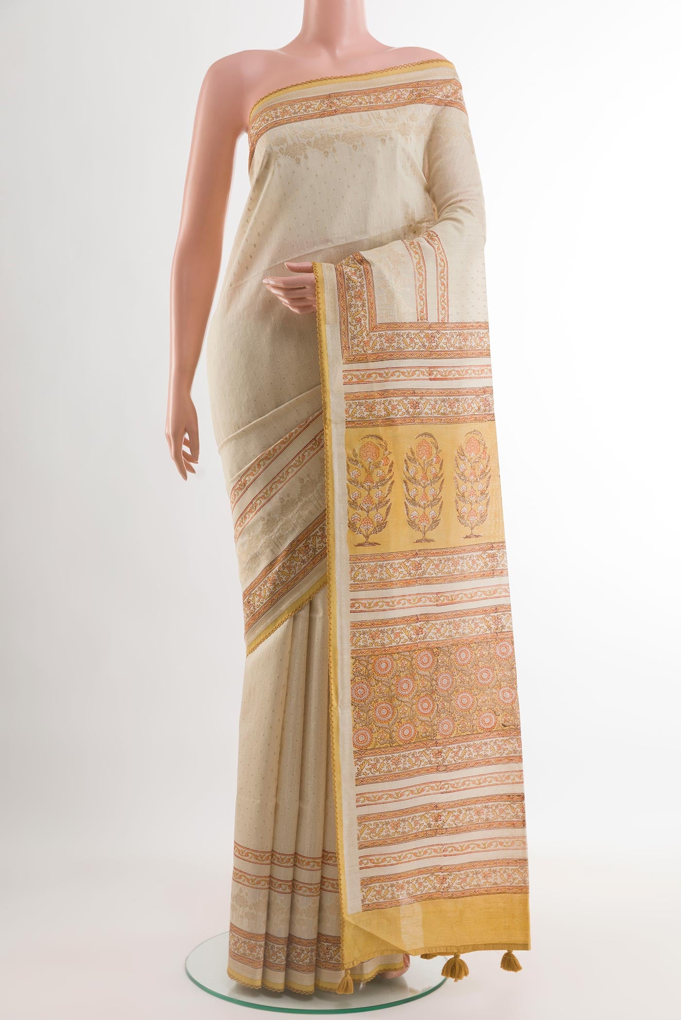 Cream Tussar Saree with Zari Butta on the body and Printed Border.  displayed on a mannequin